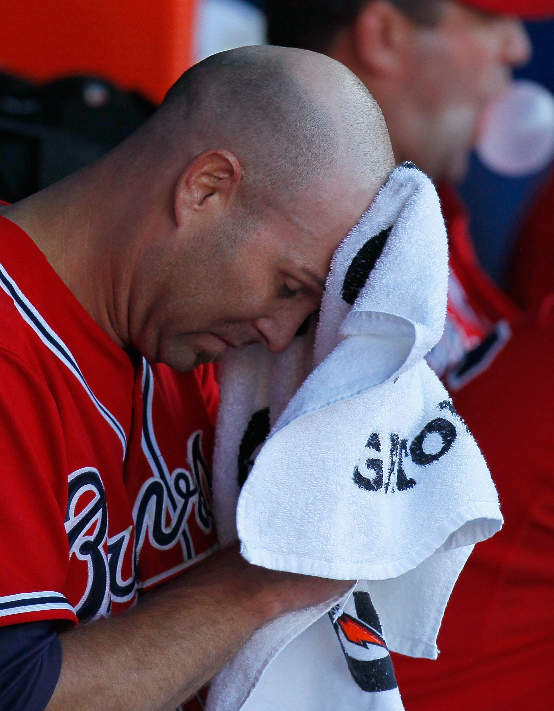 ATLANTA - OCTOBER 10:  Starting pitcher Tim Hudson #15 of the Atlanta Braves wipes his forehead in the dugout between innings against the San Francisco Giants during Game Three of the NLDS of the 2010 MLB Playoffs at Turner Field on October 10, 2010 in At