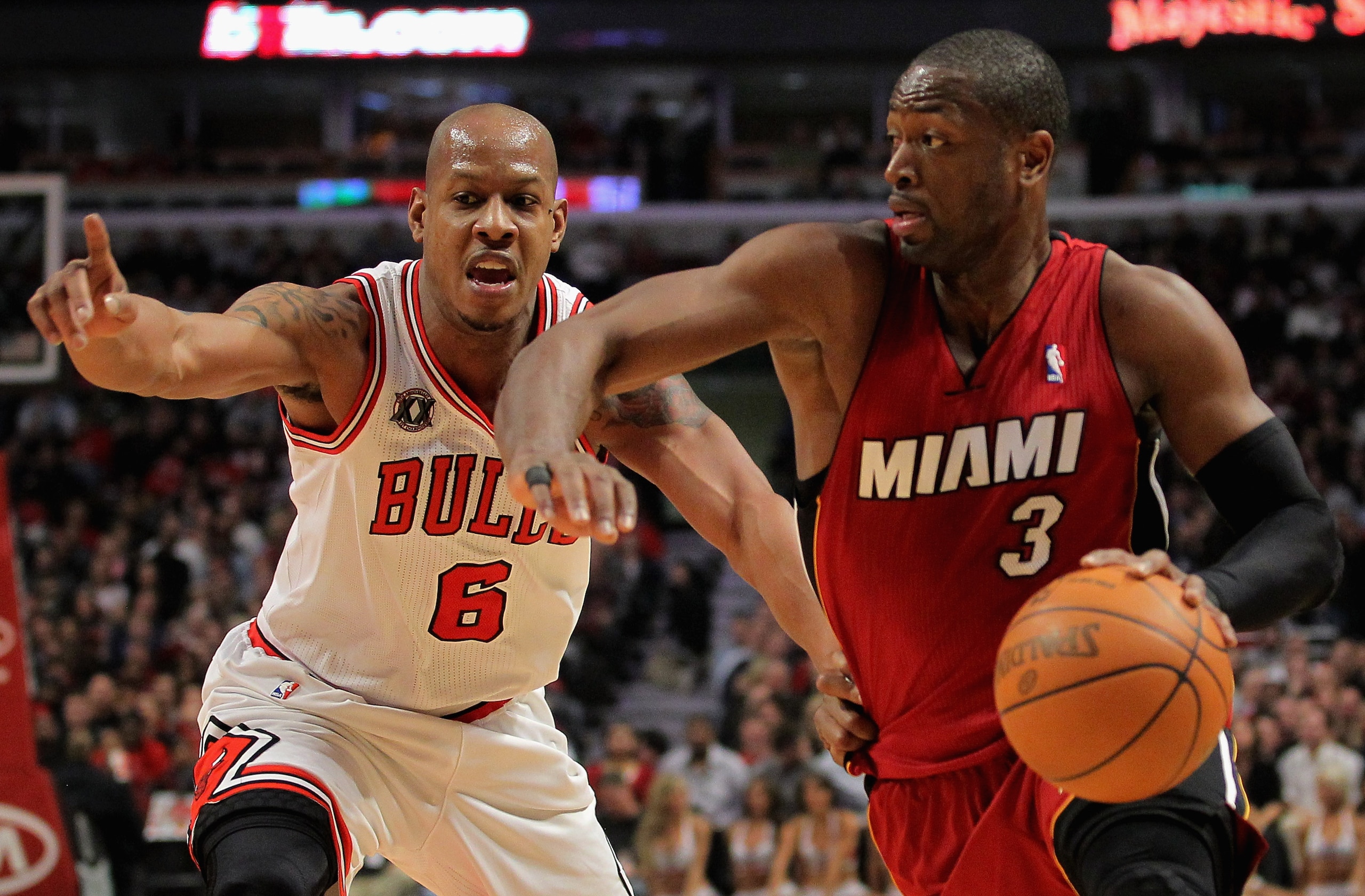 CHICAGO, IL - JANUARY 15: Dwayne Wade #3 of the Miami Heat drives to the basket against Keith Bogans #6 of the Chicago Bulls at the United Center on January 15, 2011 in Chicago, Illinois. NOTE TO USER: User expressly acknowledges and agrees that, by down CHICAGO, IL - JANUARY 15: Dwayne Wade #3 of the Miami Heat drives to the basket against Keith Bogans #6 of the Chicago Bulls at the United Center on January 15, 2011 in Chicago, Illinois. NOTE TO USER: User expressly acknowledges and agrees that, by down