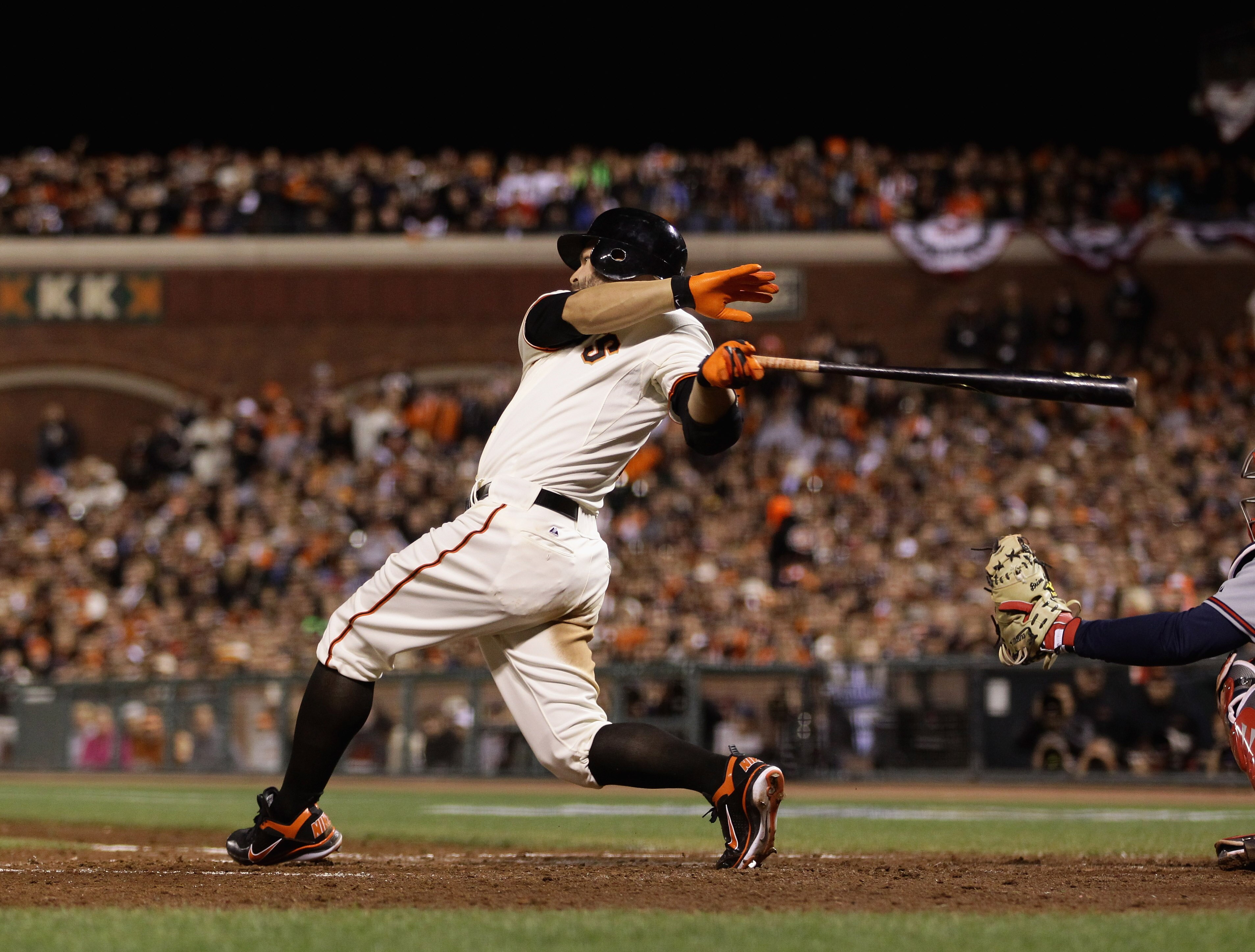 SAN FRANCISCO - OCTOBER 07:  Cody Ross #13 of the San Francisco Giants hits a single to score Buster Posey #28 to give the Giants a 1-0 lead over the Atlanta Braves in the fourth inning of game 1 of the NLDS at AT&T Park on October 7, 2010 in San Francisc