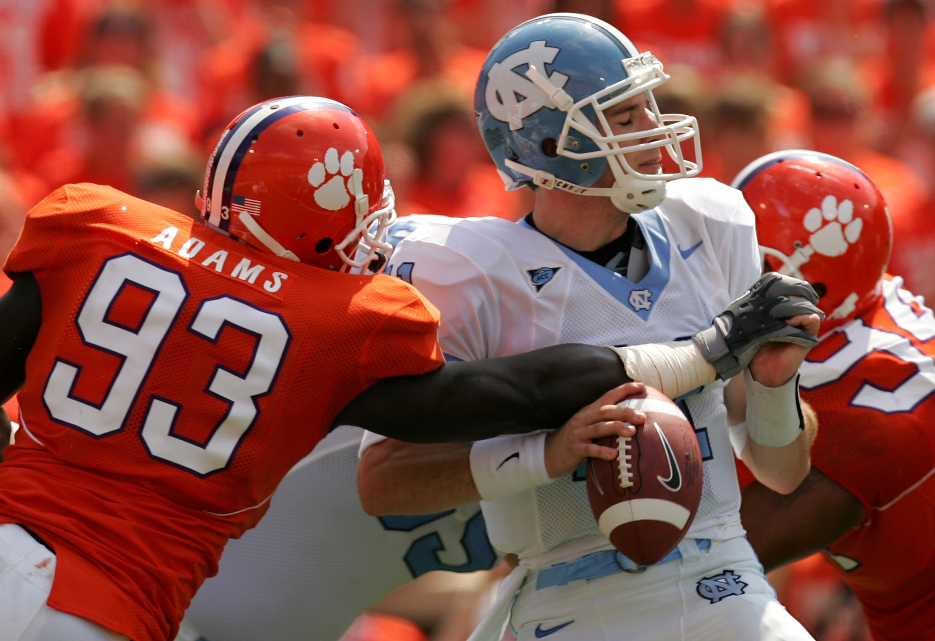 CLEMSON, SC - SEPTEMBER 23:  Cam Sexton #11 of the University of North Carolina Tar Heels is sacked by Gaines Adams #93 of the Clemson Tigers on September 23, 2006 at Memorial Stadium in Clemson, South Carolina.  (Photo By Streeter Lecka/Getty Images)