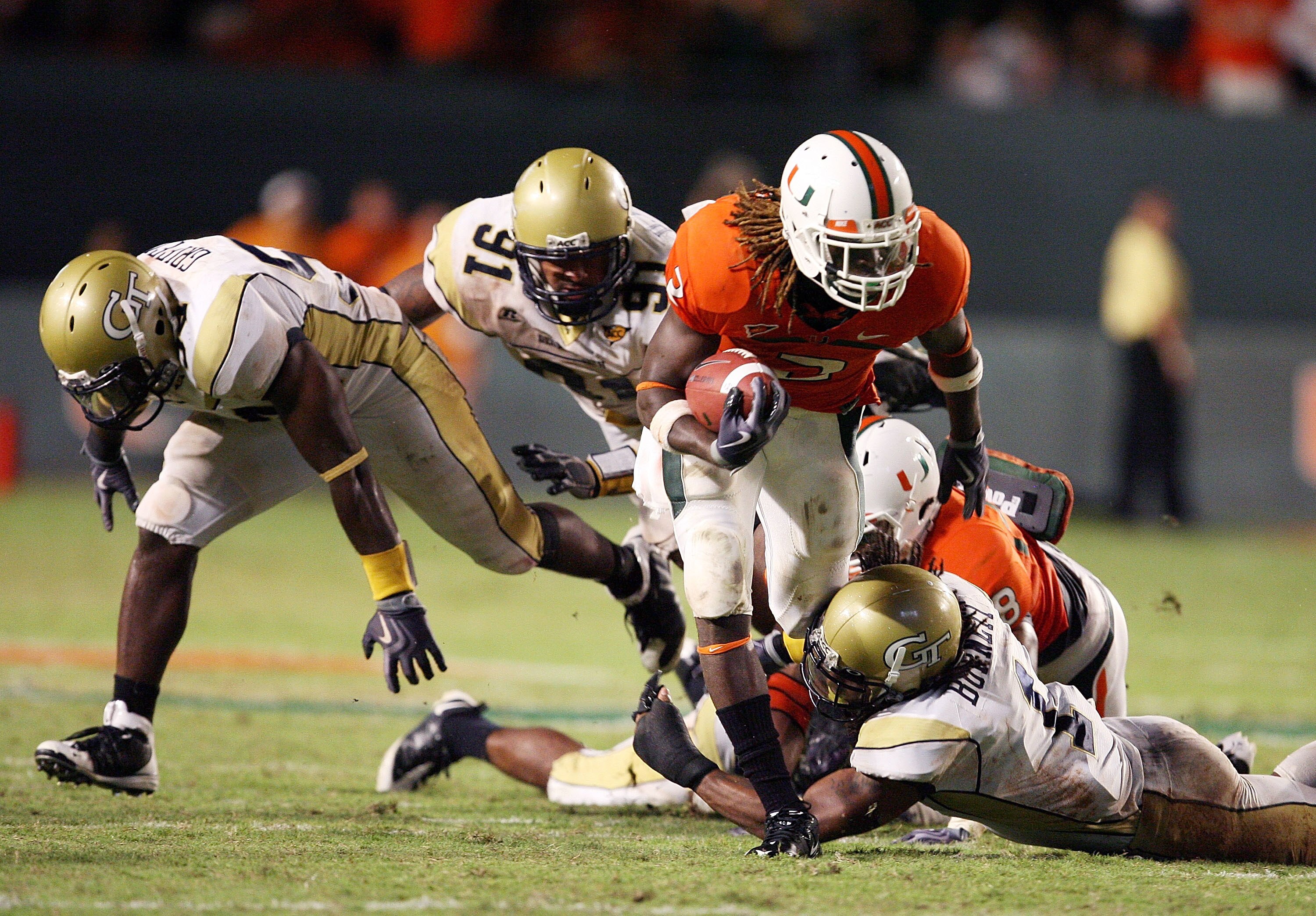 FORT LAUDERDALE, FL - SEPTEMBER 17:  Running back Graig Cooper #2 of the Miami Hurricanes breaks tackles against the Georgia Tech Yellow Jackets at Land Shark Stadium on September 17, 2009 in Fort Lauderdale, Florida. Miami defeated Georgia Tech 33-17.  (