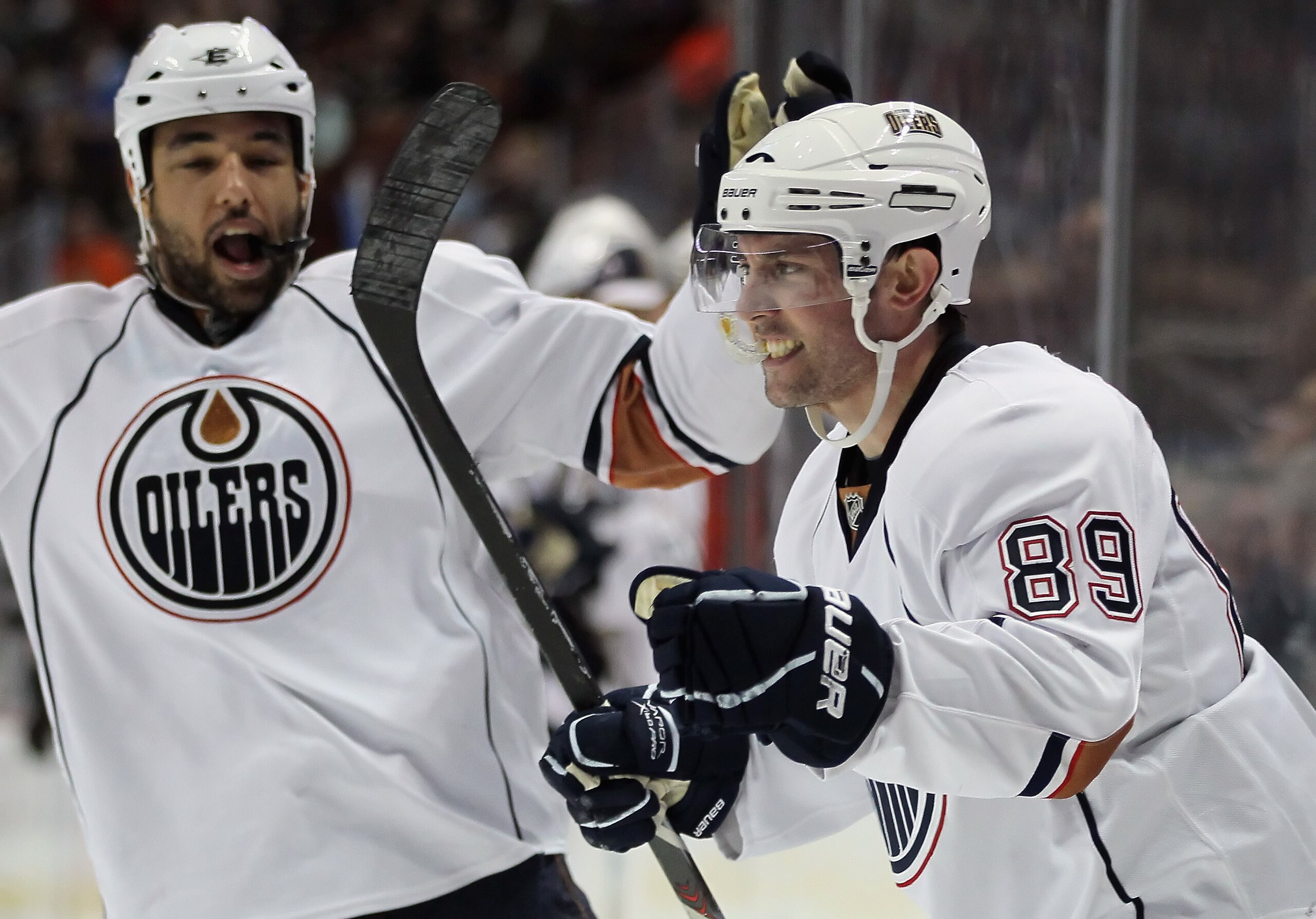 ANAHEIM, CA - JANUARY 16:  Sam Gagner #89 of the Edmonton Oilers celebrates his second period goal with teammate Theo Peckham (L) #49 against the Anaheim Ducks at the Honda Center on January 16, 2011 in Anaheim, California. The Ducks defeated the Oilers 3