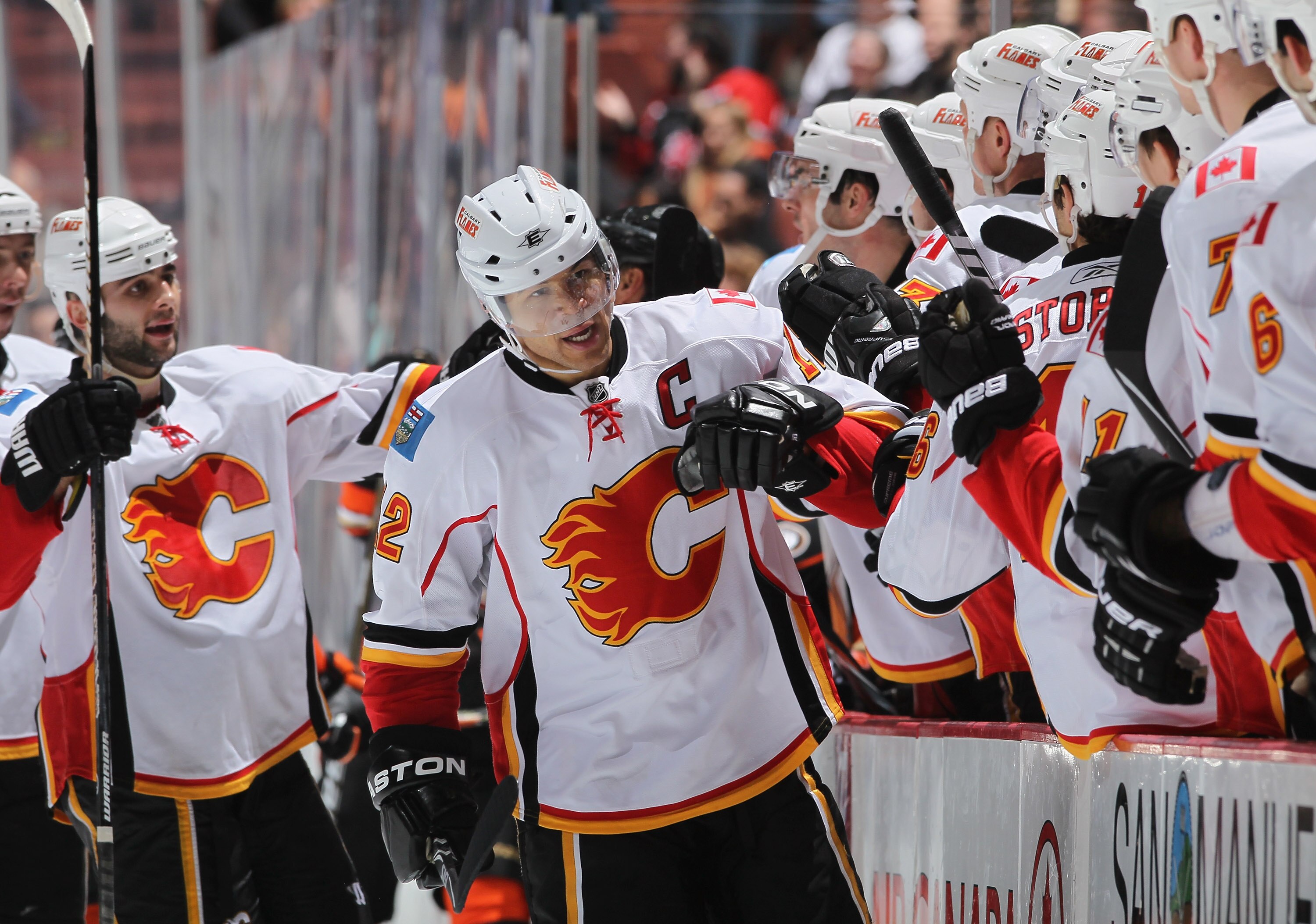 ANAHEIM, CA - DECEMBER 10:  Jerome Iginla #12 of the Calgary Flames receives high fives from the bench after scoring a goal against the Anaheim Ducks in the third period at the Honda Center on December 10, 2010 in Anaheim, California. The Ducks defeated t
