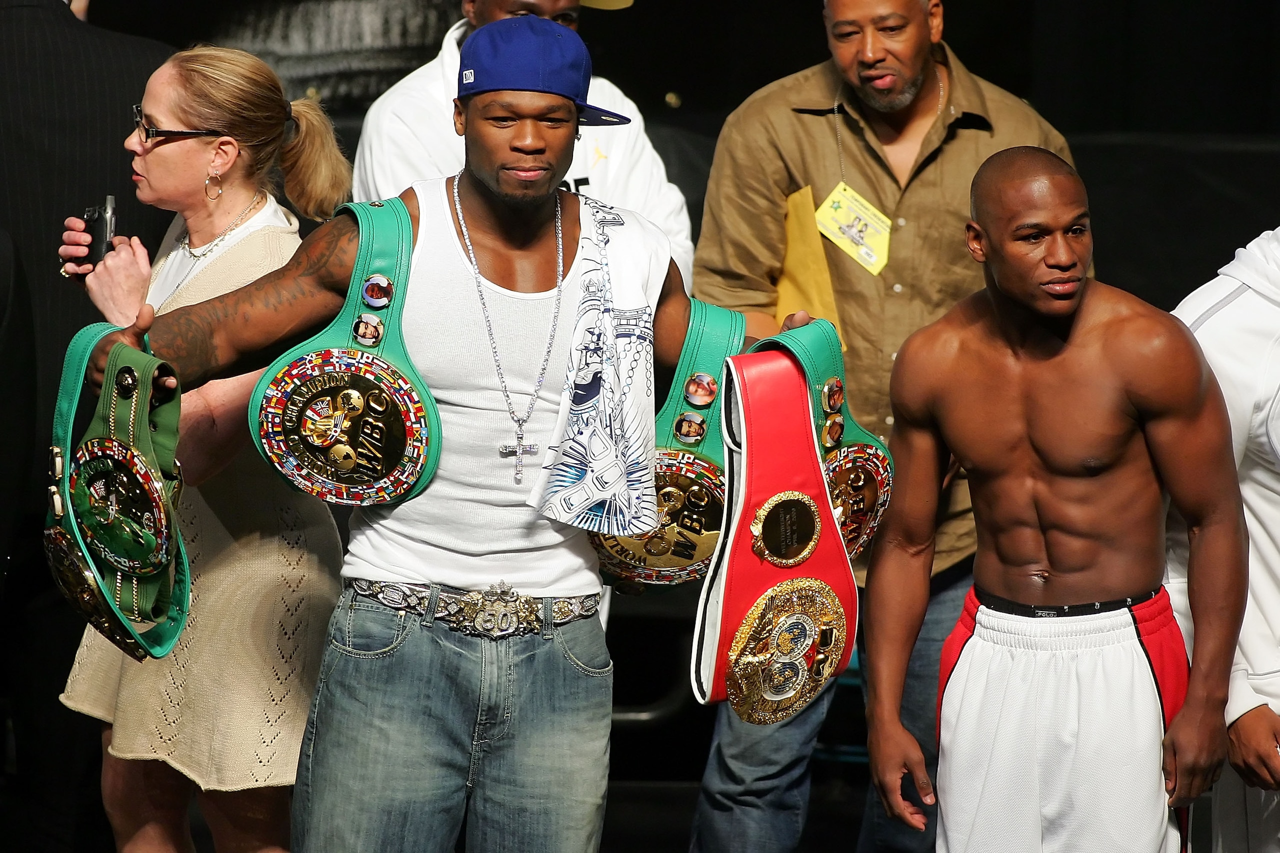 LAS VEGAS - MAY 04:  Rapper 50 Cent holds up Floyd Mayweather Jr. belts at the weigh-in at the MGM Grand Garden Arena May 4, 2007 in Las Vegas, Nevada. Mayweather Jr. will fight Oscar De La Hoya for the WBC super welterweight championship at the MGM on Ma