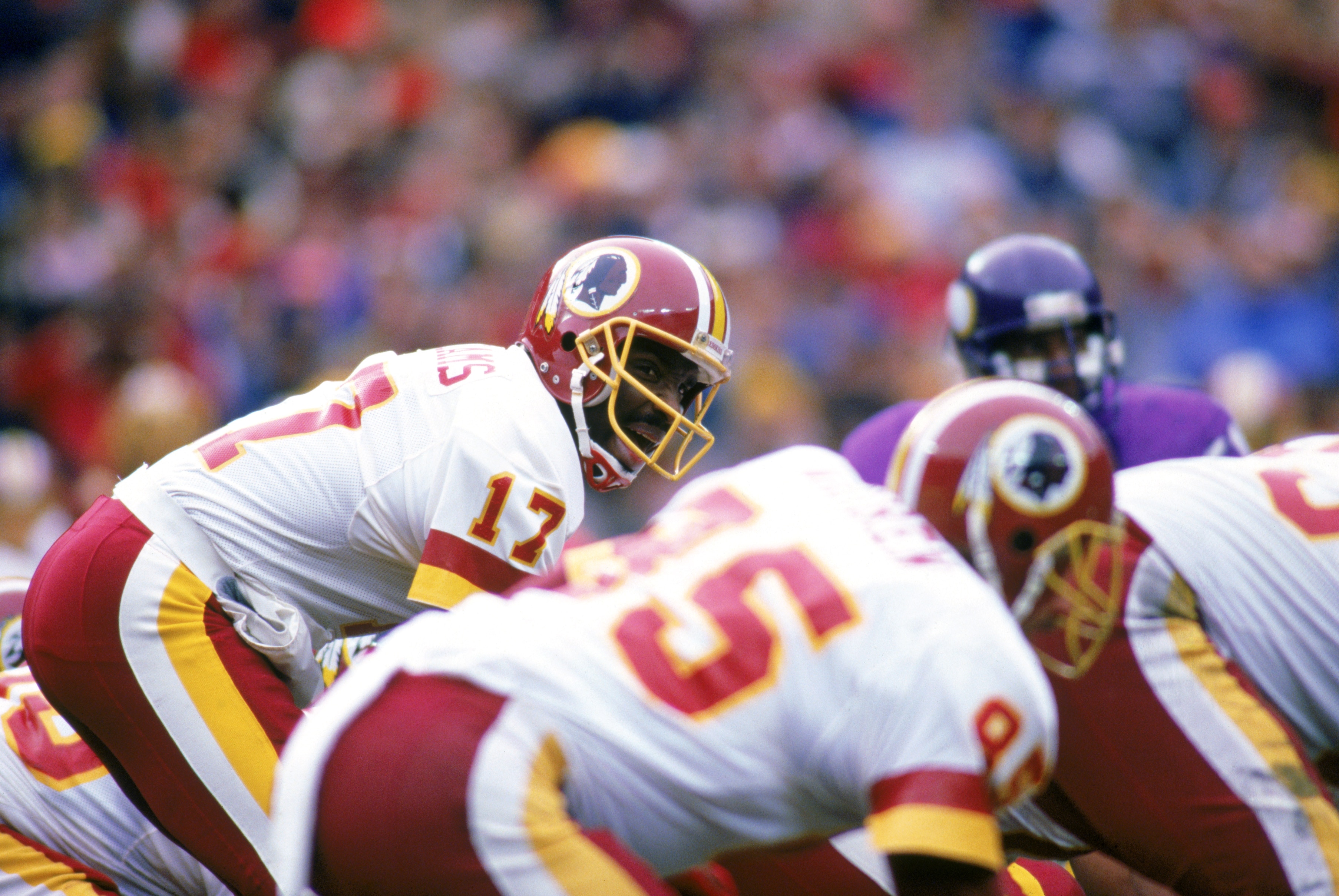 WASHINGTON, DC - JANUARY 17:  Quarterback Doug Williams #17 of the Washington Redskins calls for the snap at the line of scrimmage against the Minnesota Vikings during the 1987 NFC Championship game at RFK Memorial Stadium on January 17, 1988 in Washingto