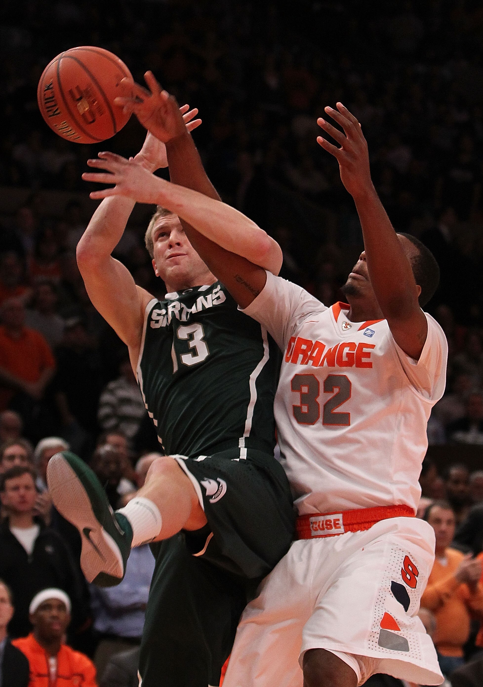NEW YORK, NY - DECEMBER 07: Austin Thorton #13 of the Michigan Spartans rebounds the ball against Kris Joseph #32 of Syracuse Orange during their game at the Jimmy V Classic at Madison Square Garden on December 7, 2010 in New York City.  (Photo by Nick La