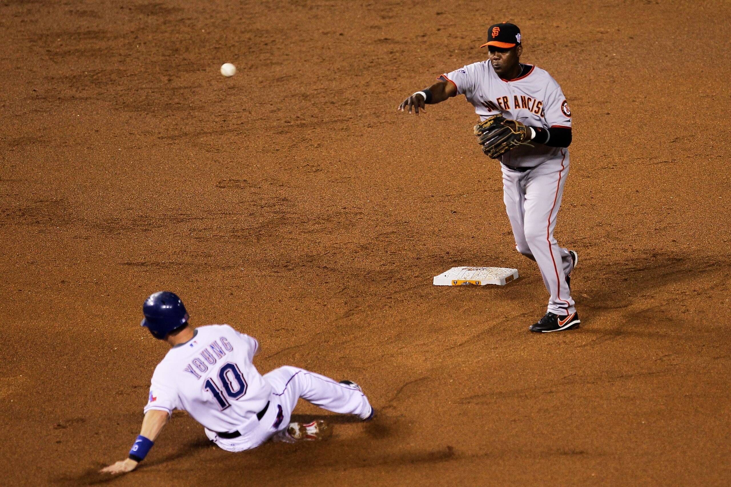 ARLINGTON, TX - OCTOBER 31:  Edgar Renteria #16 of the San Francisco Giants turns a successful double play over a sliding Michael Young #10 of the Texas Rangers on a ball hit by Josh Hamilton #32 in the bottom of the first inning of Game Four of the 2010