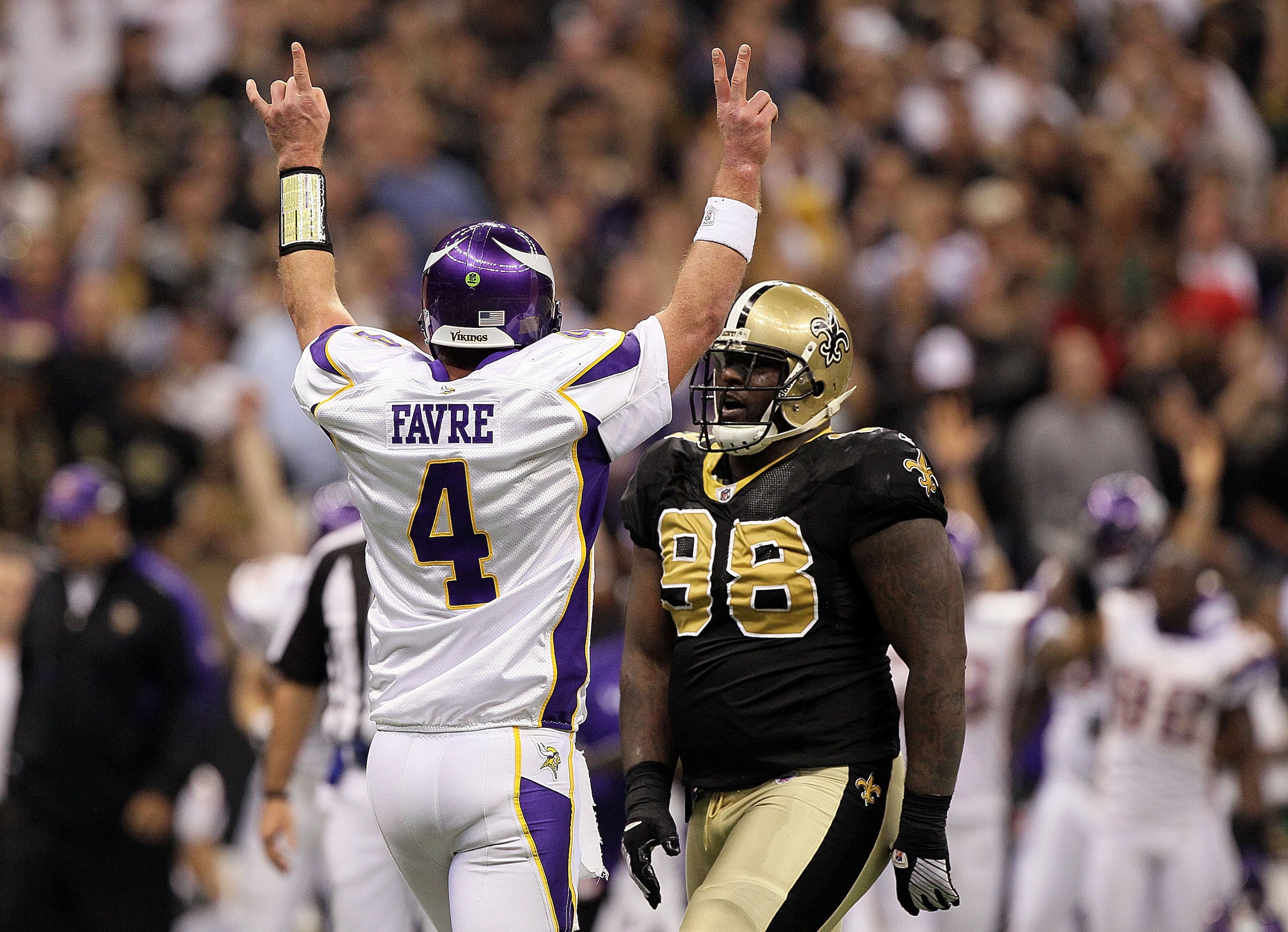 NEW ORLEANS - JANUARY 24:  Brett Favre #4 of the Minnesota Vikings celebrates after throwing for a touchdown in the first quarter as Sedrick Ellis #98 of the New Orleans Saints looks on during the NFC Championship Game at the Louisana Superdome on January