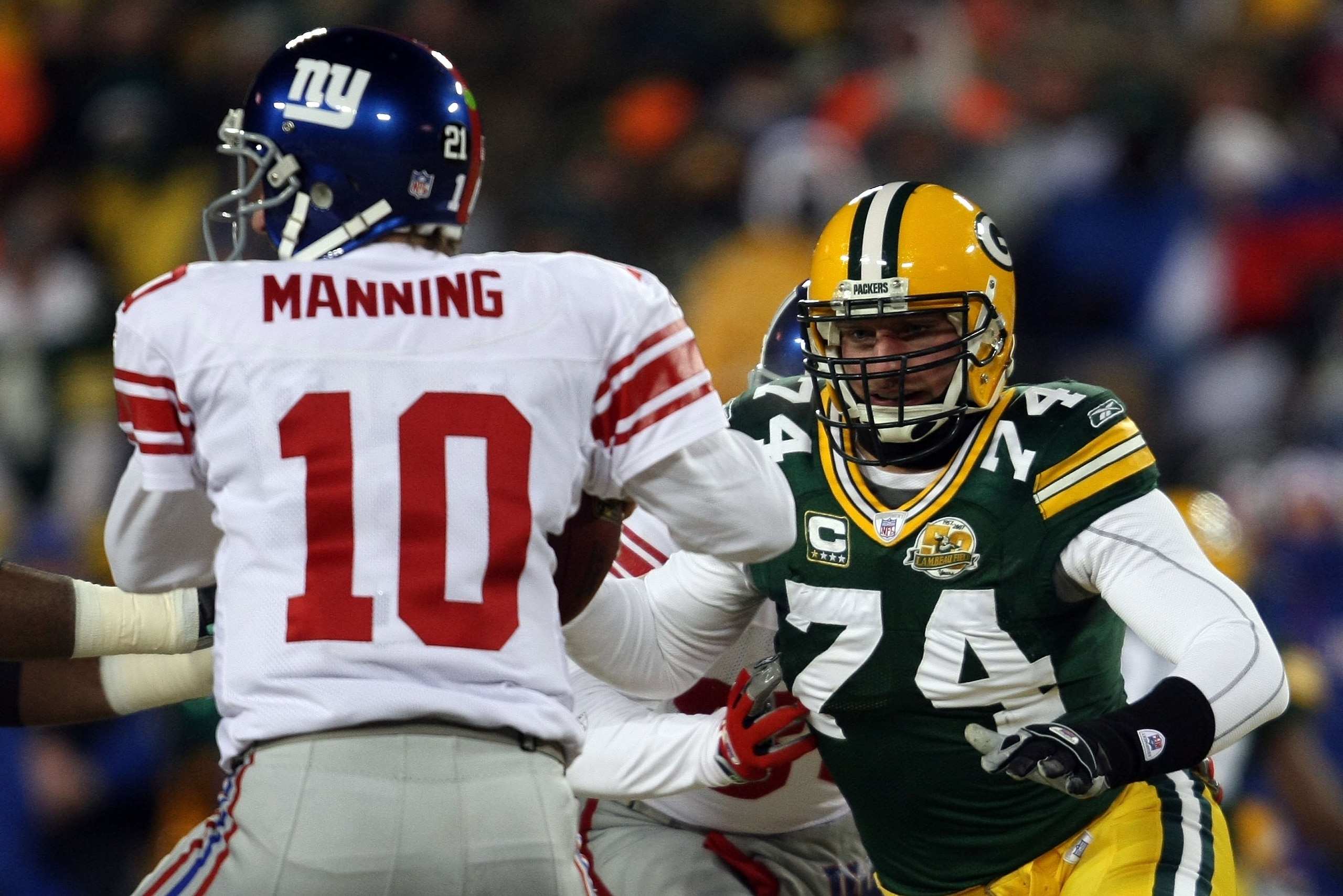 GREEN BAY, WI - JANUARY 20:  Defensive end Aaron Kampman #74 of the Green Bay Packers rushes in at Eli Manning #10 of the New York Giants during the NFC championship game on January 20, 2008 at Lambeau Field in Green Bay, Wisconsin. The Giants defeated th