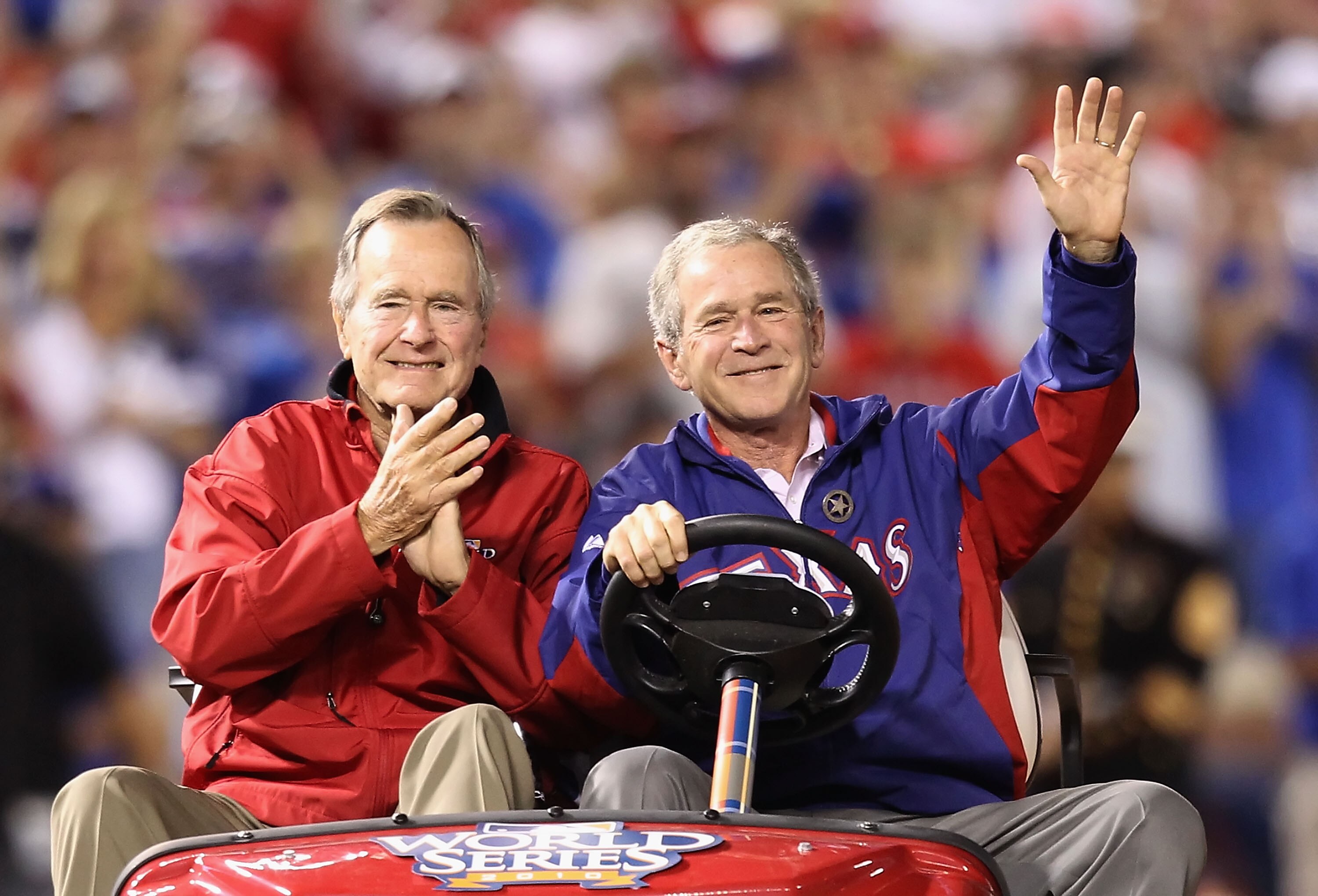 ARLINGTON, TX - OCTOBER 31:  Former President of the United States, George W. Bush, and his father Former President George H.W. Bush wave to the crowd before the Texas Rangers host the San Francisco Giants in Game Four of the 2010 MLB World Series at Rang