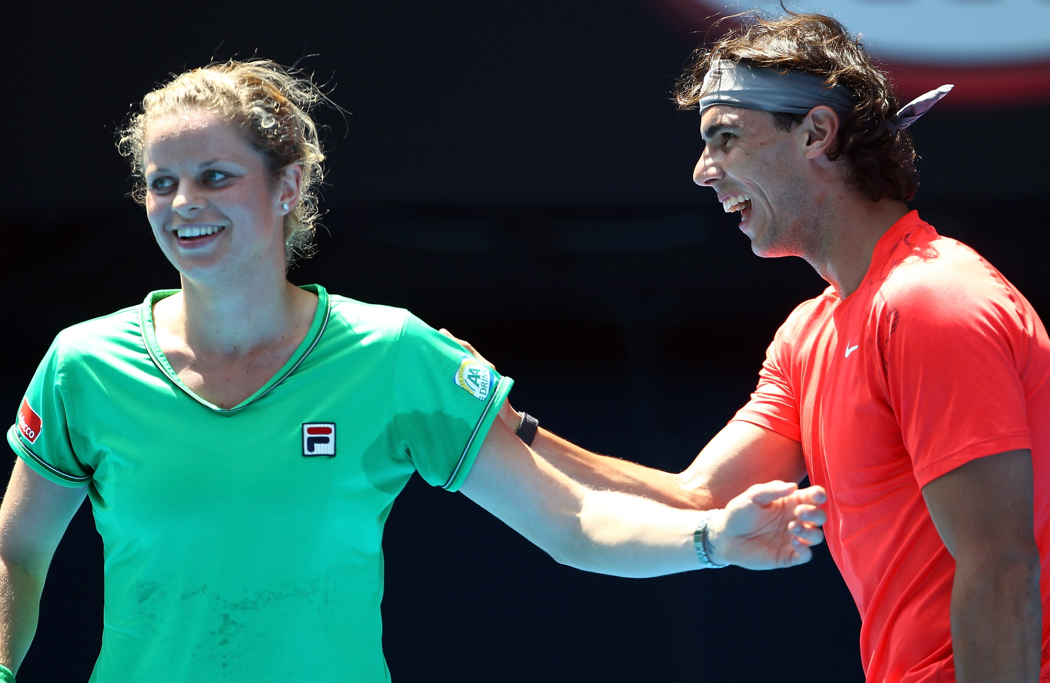 MELBOURNE, AUSTRALIA - JANUARY 16:  Rafael Nadal of Spain and Kim Clijsters of Belgium enjoy the tennis during the 'Rally For Relief' charity exhibition match ahead of the 2011 Australian Open at Melbourne Park on January 16, 2011 in Melbourne, Australia.