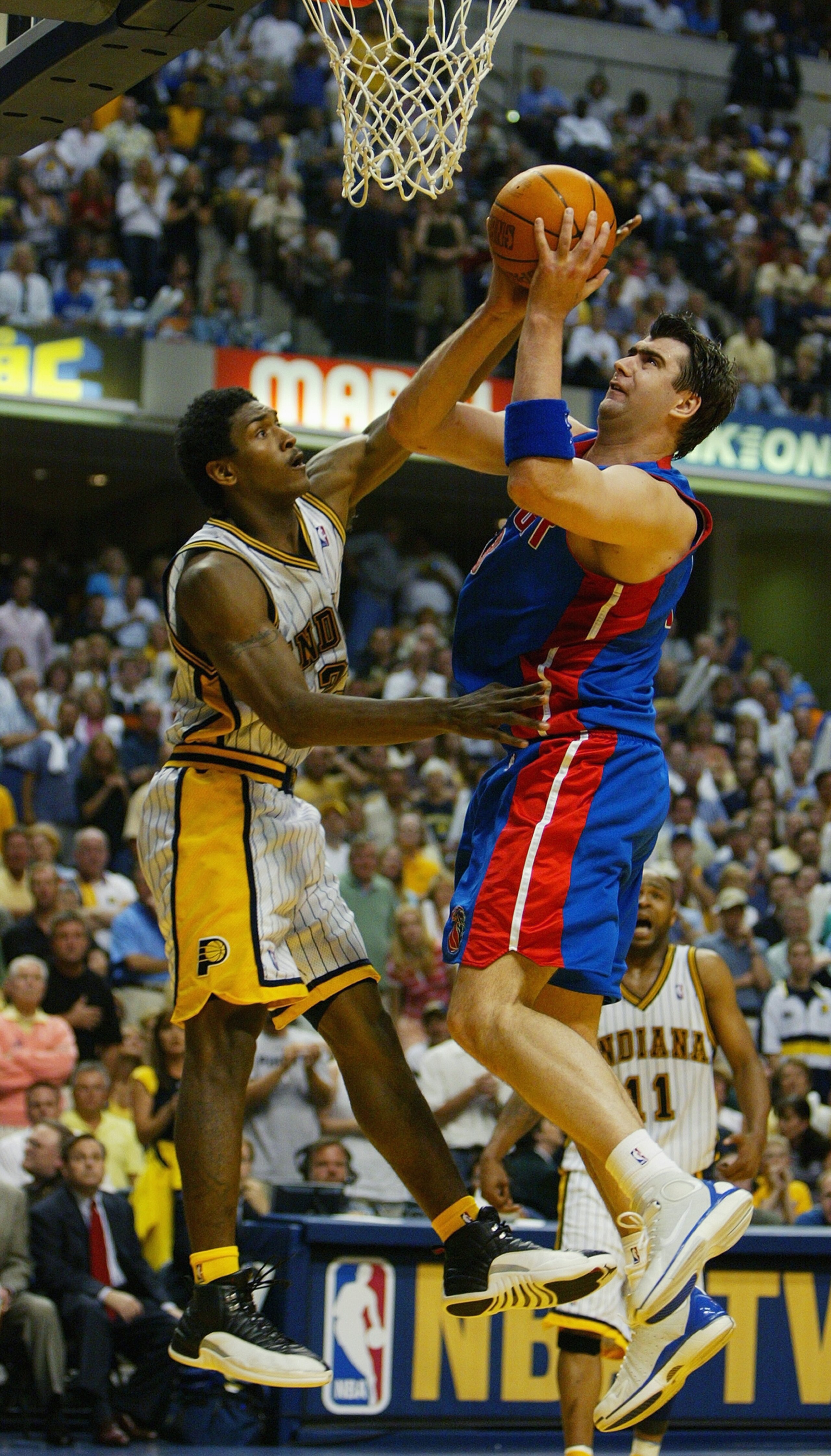 INDIANAPOLIS - MAY 22: Mehmet Okur #13 of the Detroit Pistons shoots over Ron Artest #23 of the Indiana Pacers in Game one of the Eastern Conference Finals during the 2004 NBA Playoffs at Conseco Fieldhouse on May 22, 2004 in Indianapolis, Indiana. The INDIANAPOLIS - MAY 22: Mehmet Okur #13 of the Detroit Pistons shoots over Ron Artest #23 of the Indiana Pacers in Game one of the Eastern Conference Finals during the 2004 NBA Playoffs at Conseco Fieldhouse on May 22, 2004 in Indianapolis, Indiana. The
