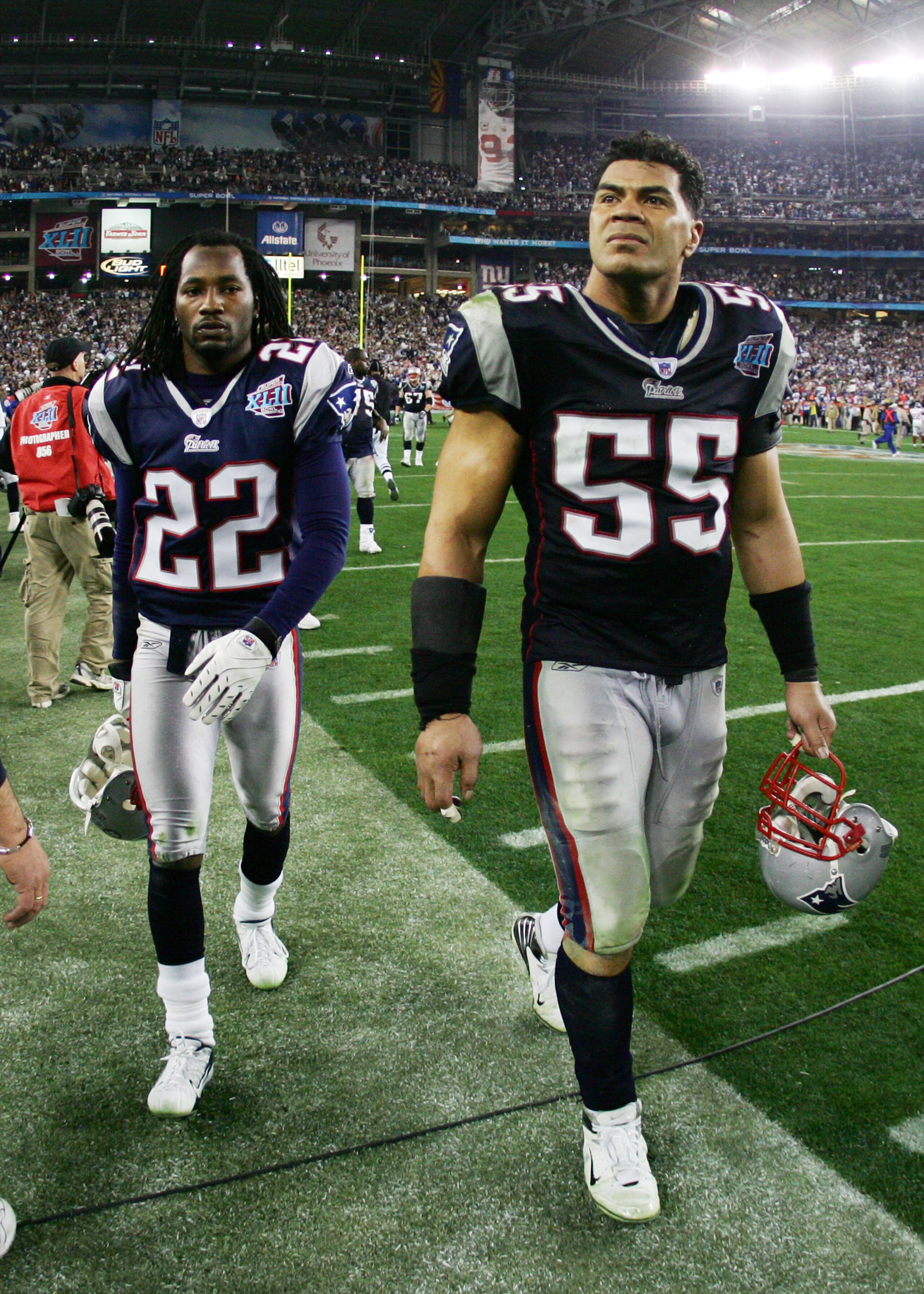 GLENDALE, AZ - FEBRUARY 03:  Junior Seau #55 and Asante Samuel #22 of the New England Patriots walks off the field after losing to the New York Giants 17-14 during Super Bowl XLII on February 3, 2008 at the University of Phoenix Stadium in Glendale, Arizo