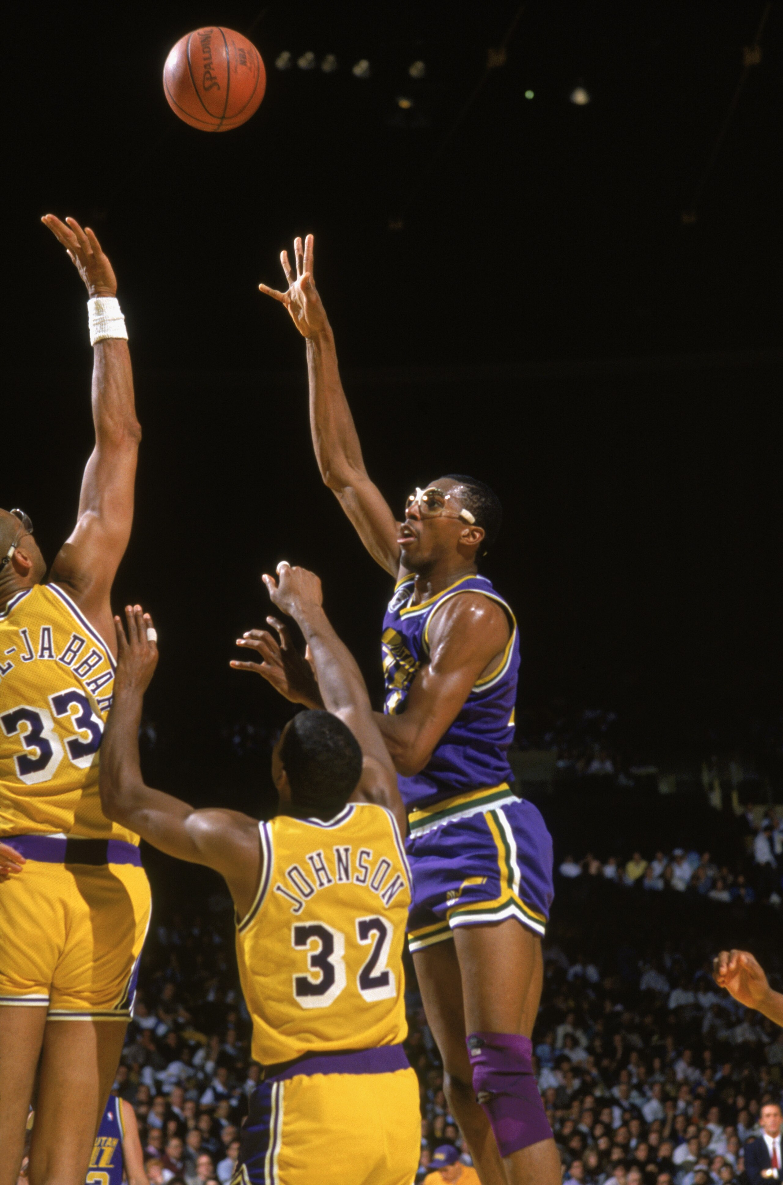 SALT LAKE CITY - 1988:  Thurl Bailey #41 of the Utah Jazz shoots over Kareem Abdul-Jabbar #33 and Magic Johnson #32 of the Los Angeles Lakers during an NBA game at The Salt Palace in Salt Lake City, Utah in 1988. (Photo by Rick Stewart/Getty Images)