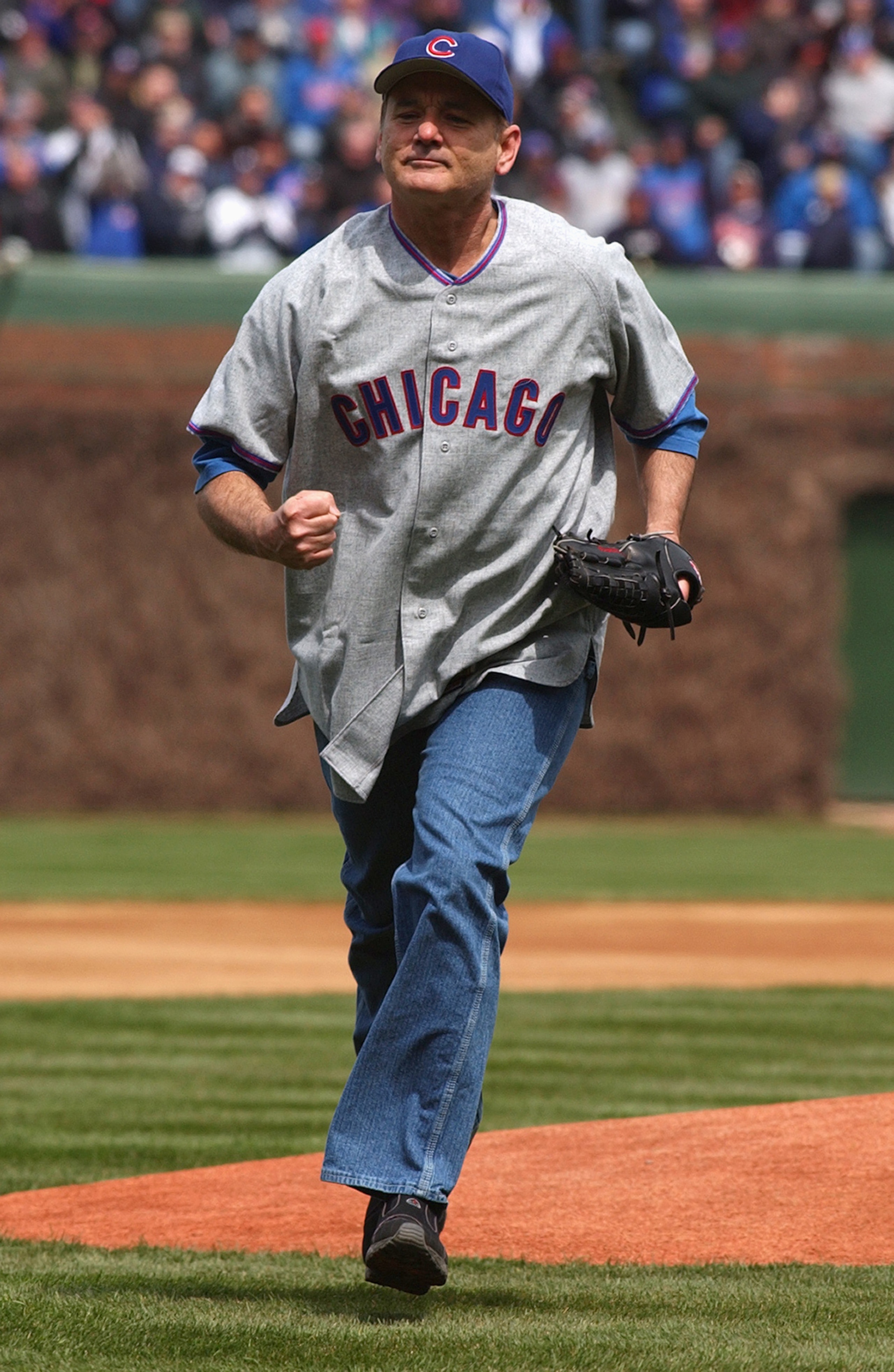 CHICAGO - APRIL 12:  Actor Bill Murray runs to home plate after throwing the ceremonial first pitch prior to the Chicago Cubs home opener against the Pittsburgh Pirates on April 12, 2004 at Wrigley Field in Chicago, Illinois. The Pirates defeated the Cubs