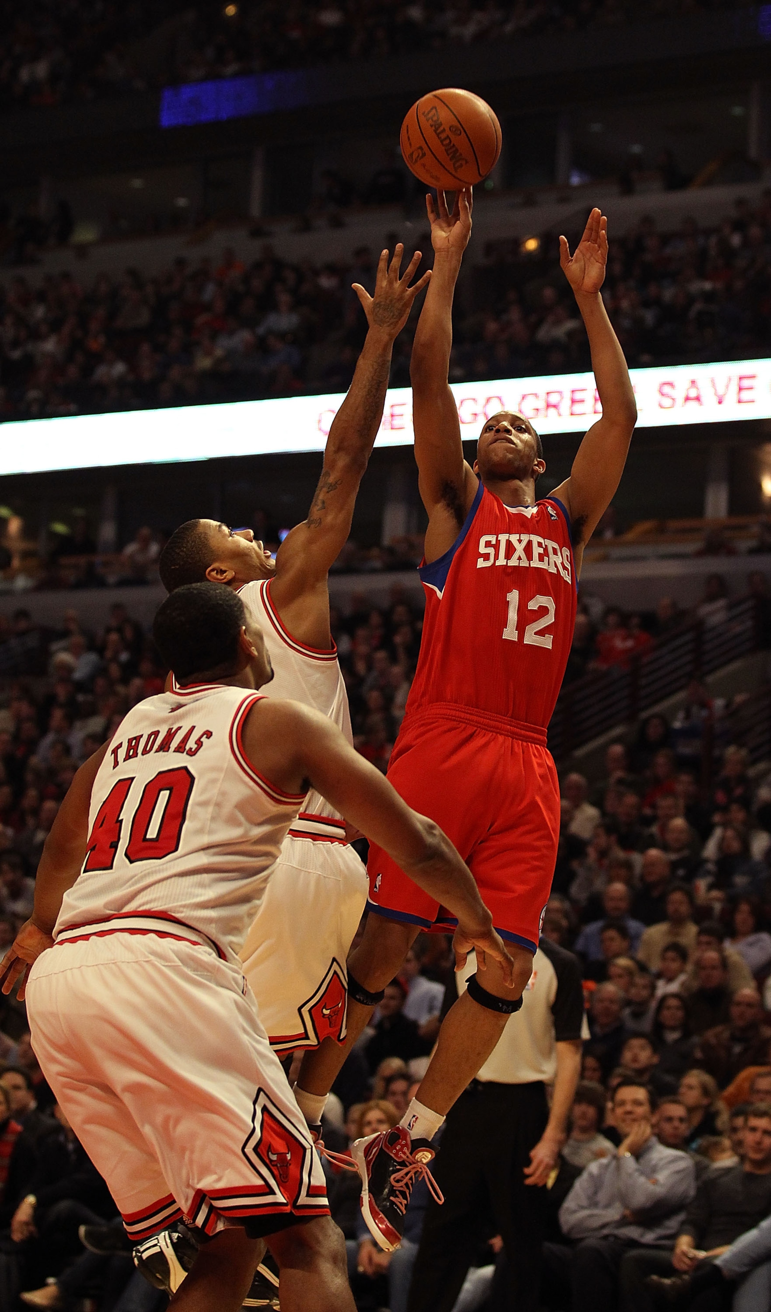 CHICAGO, IL - DECEMBER 21: Evan Turner #12 of the Philadelphia 76ers puts up a shot over Derrick Rose #1 and Kurt Thomas #40 of the Chicago Bulls at the United Center on December 21, 2010 in Chicago, Illinois. NOTE TO USER: User expressly acknowledges and CHICAGO, IL - DECEMBER 21: Evan Turner #12 of the Philadelphia 76ers puts up a shot over Derrick Rose #1 and Kurt Thomas #40 of the Chicago Bulls at the United Center on December 21, 2010 in Chicago, Illinois. NOTE TO USER: User expressly acknowledges and