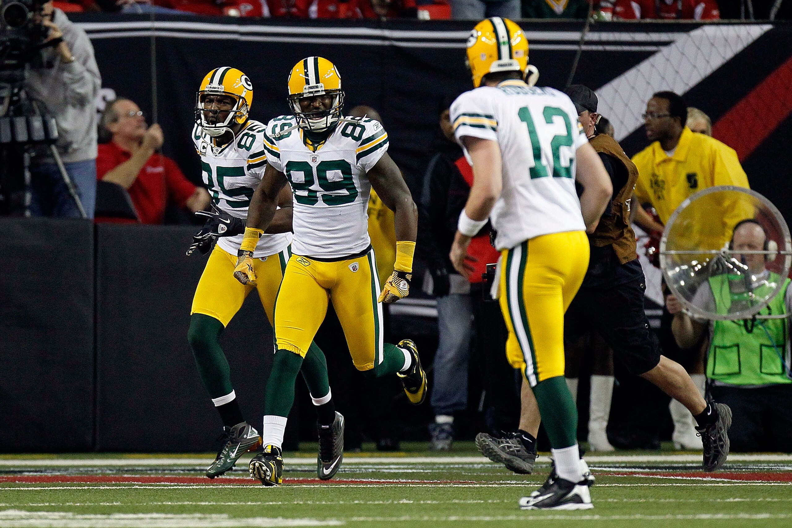 ATLANTA, GA - JANUARY 15:  (L-R) Greg Jennings #85, James Jones #89 and Aaron Rodgers #12 of the Green Bay Packers celebrate after Jones caucht a 20-yard touchdown pass from Rodgers in the second quarter against the Atlanta Falcons during their 2011 NFC d