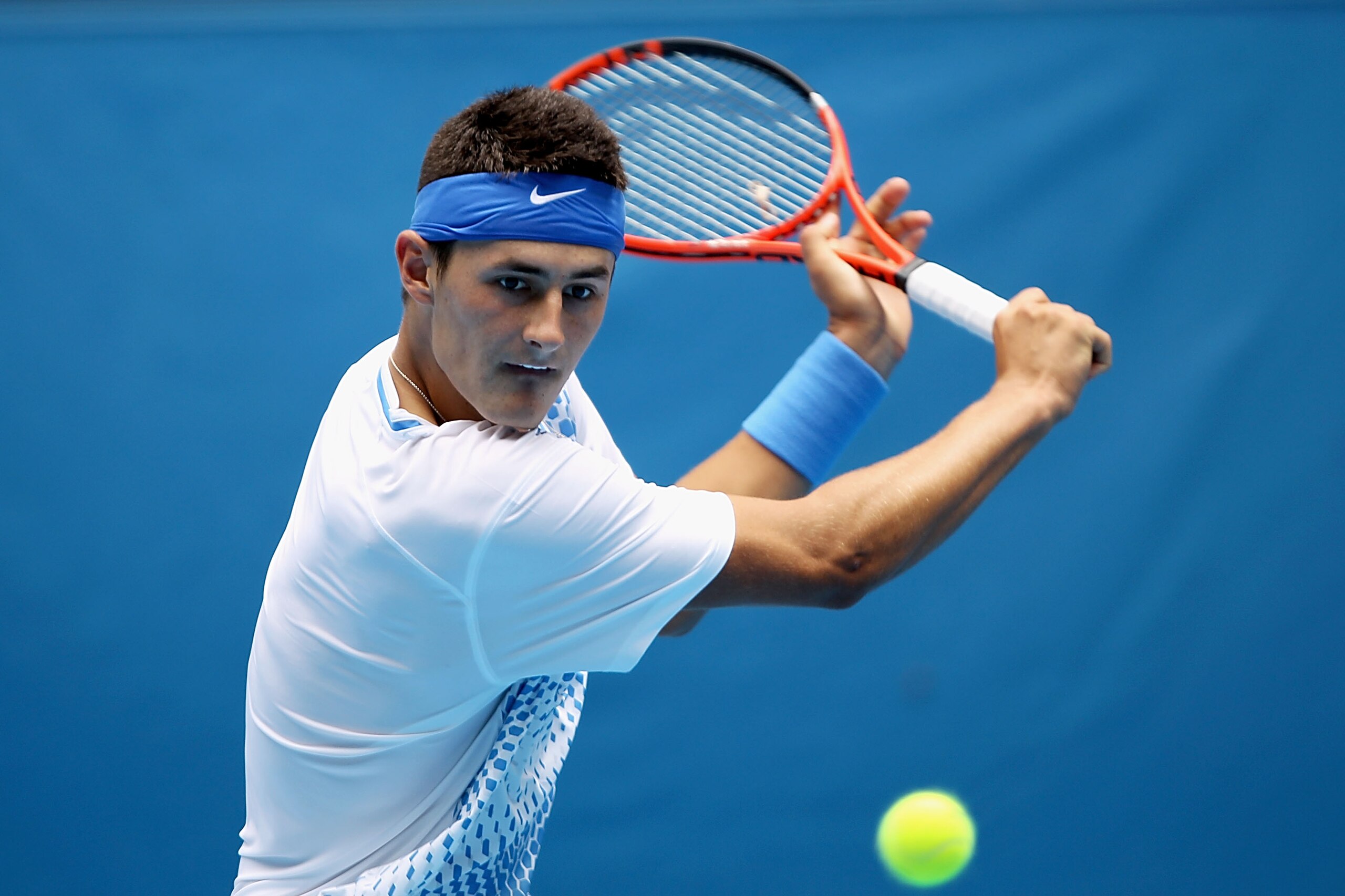 MELBOURNE, AUSTRALIA - JANUARY 18:  Bernard Tomic of Australia plays a backhand in his first round match against Jeremy Chardy of France during day two of the 2011 Australian Open at Melbourne Park on January 18, 2011 in Melbourne, Australia.  (Photo by C