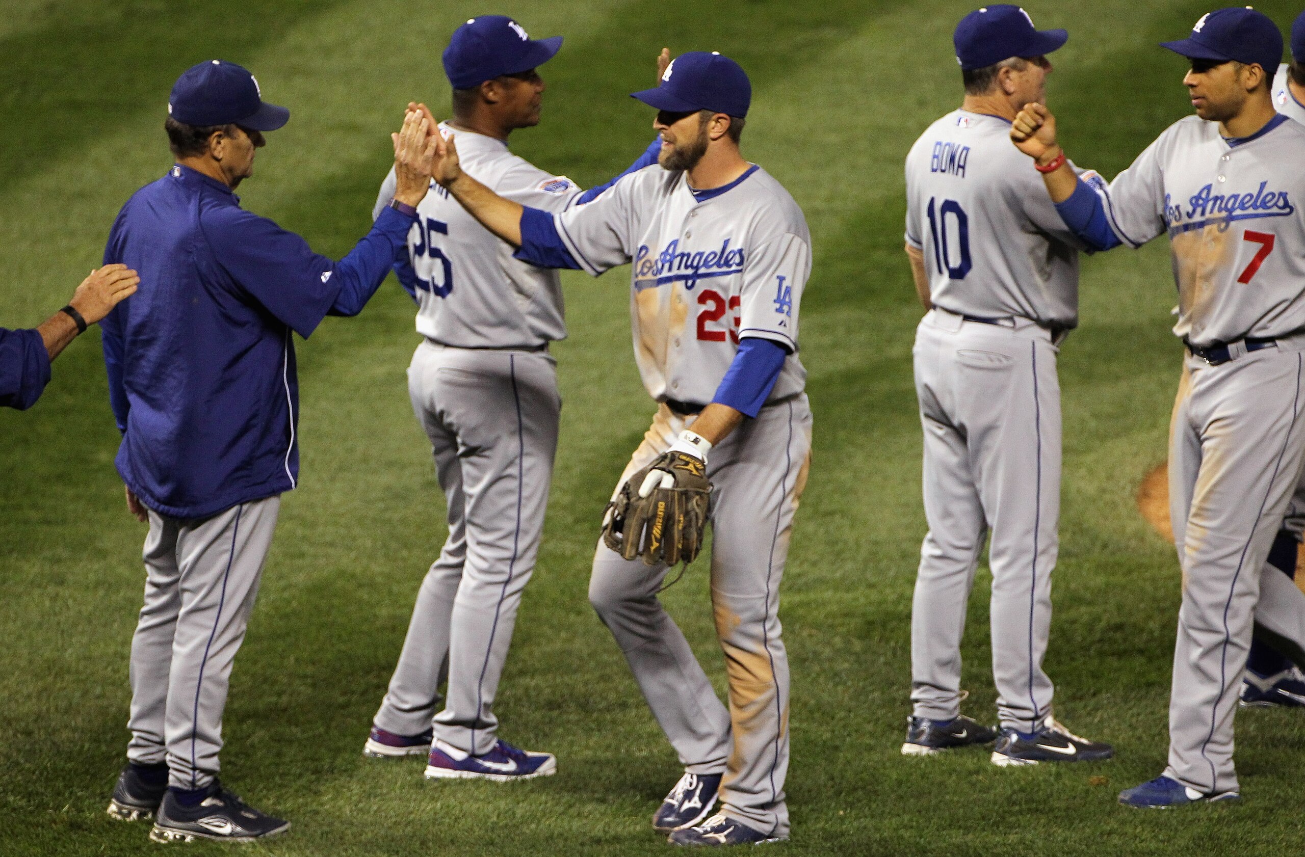 DENVER - SEPTEMBER 27: Manager Joe Torre (L)high fives Casey Blake #23 as the Los Angeles Dodgers celebrate their victory over the Colorado Rockies at Coors Field on September 25, 2010 in Denver, Colorado.The Dodgers defeated the Rockies 3-1. (Photo by DENVER - SEPTEMBER 27: Manager Joe Torre (L)high fives Casey Blake #23 as the Los Angeles Dodgers celebrate their victory over the Colorado Rockies at Coors Field on September 25, 2010 in Denver, Colorado.The Dodgers defeated the Rockies 3-1. (Photo by