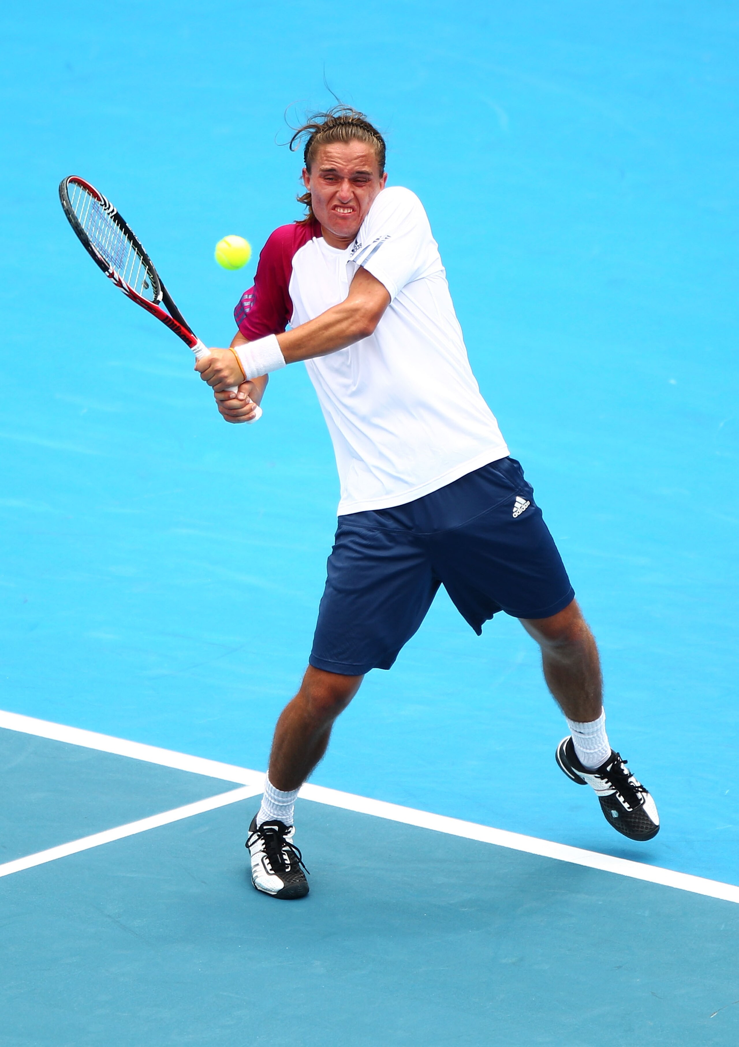 SYDNEY, AUSTRALIA - JANUARY 13:  Alexandr Dolgopolov of Ukraine plays a backhand in his match against Gilles Simon of France during day five of the 2011 Medibank International at Sydney Olympic Park Tennis Centre on January 13, 2011 in Sydney, Australia.