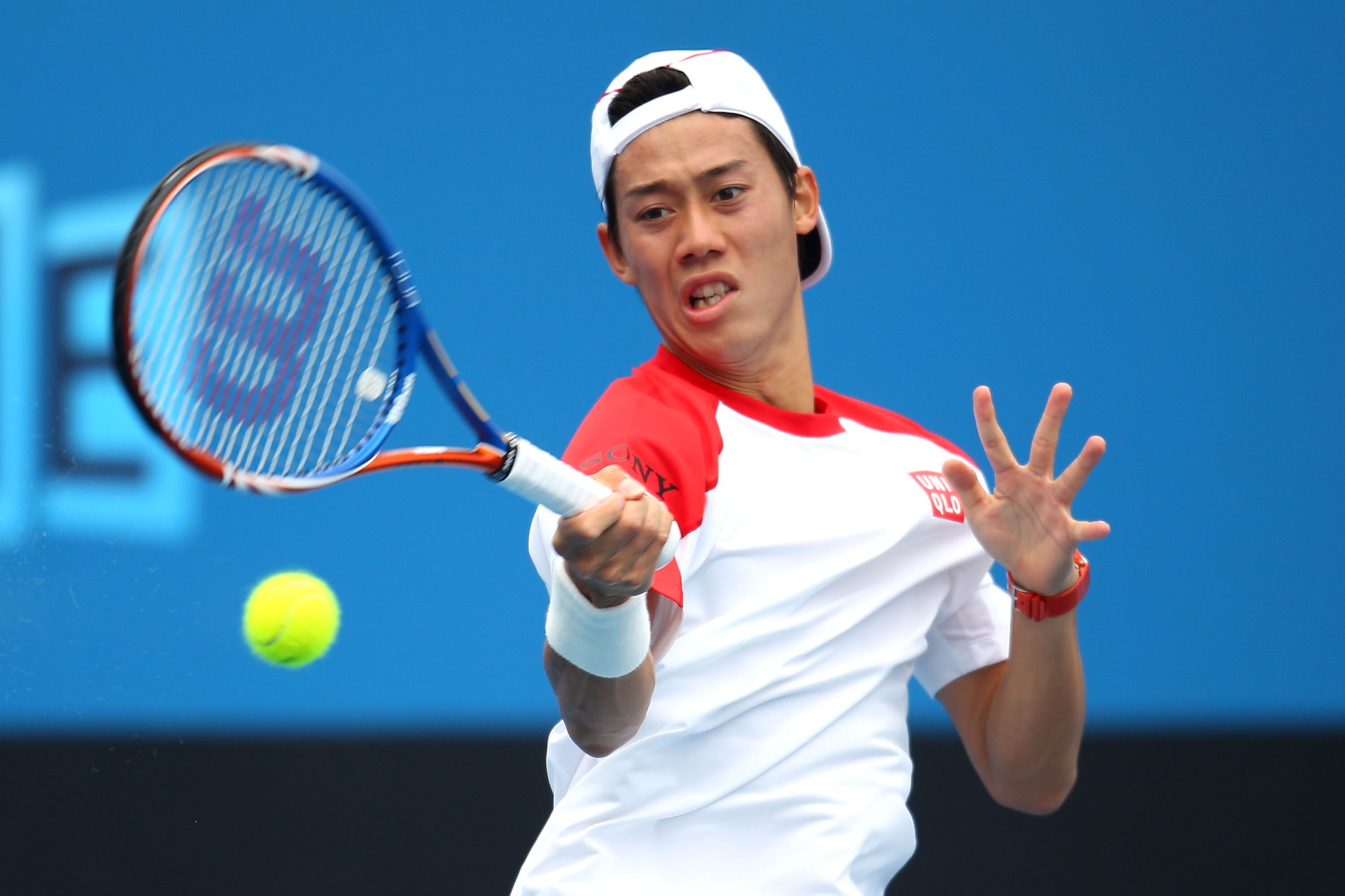 MELBOURNE, AUSTRALIA - JANUARY 17:  Kei Nishikori of Japan plays a forehand in his first round match against  Fabio Fognini of Italy during day one of the 2011 Australian Open at Melbourne Park on January 17, 2011 in Melbourne, Australia.  (Photo by Scott