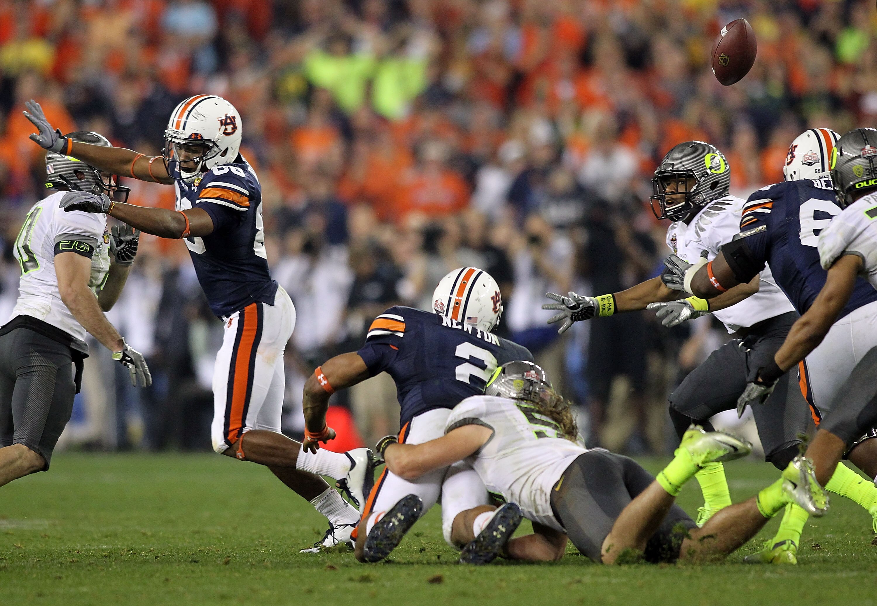 GLENDALE, AZ - JANUARY 10:  Quarterback Cameron Newton #2 of the Auburn Tigers has the ball knocked out from behind by Casey Matthews #55 of the Oregon Ducks in the fourth quarter in the Tostitos BCS National Championship Game at University of Phoenix Sta