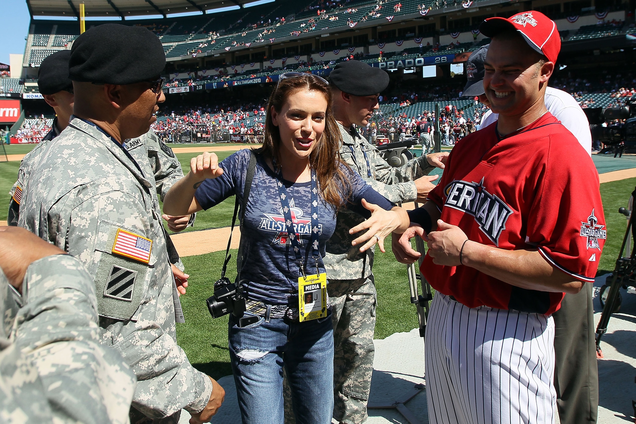 ANAHEIM, CA - JULY 12:  Actress Alyssa Milano talks with members of the United States Armed Forces and American League All-Star Nick Swisher #33 of the New York Yankees during Gatorade All-Star Workout Day at Angel Stadium of Anaheim on July 12, 2010 in A