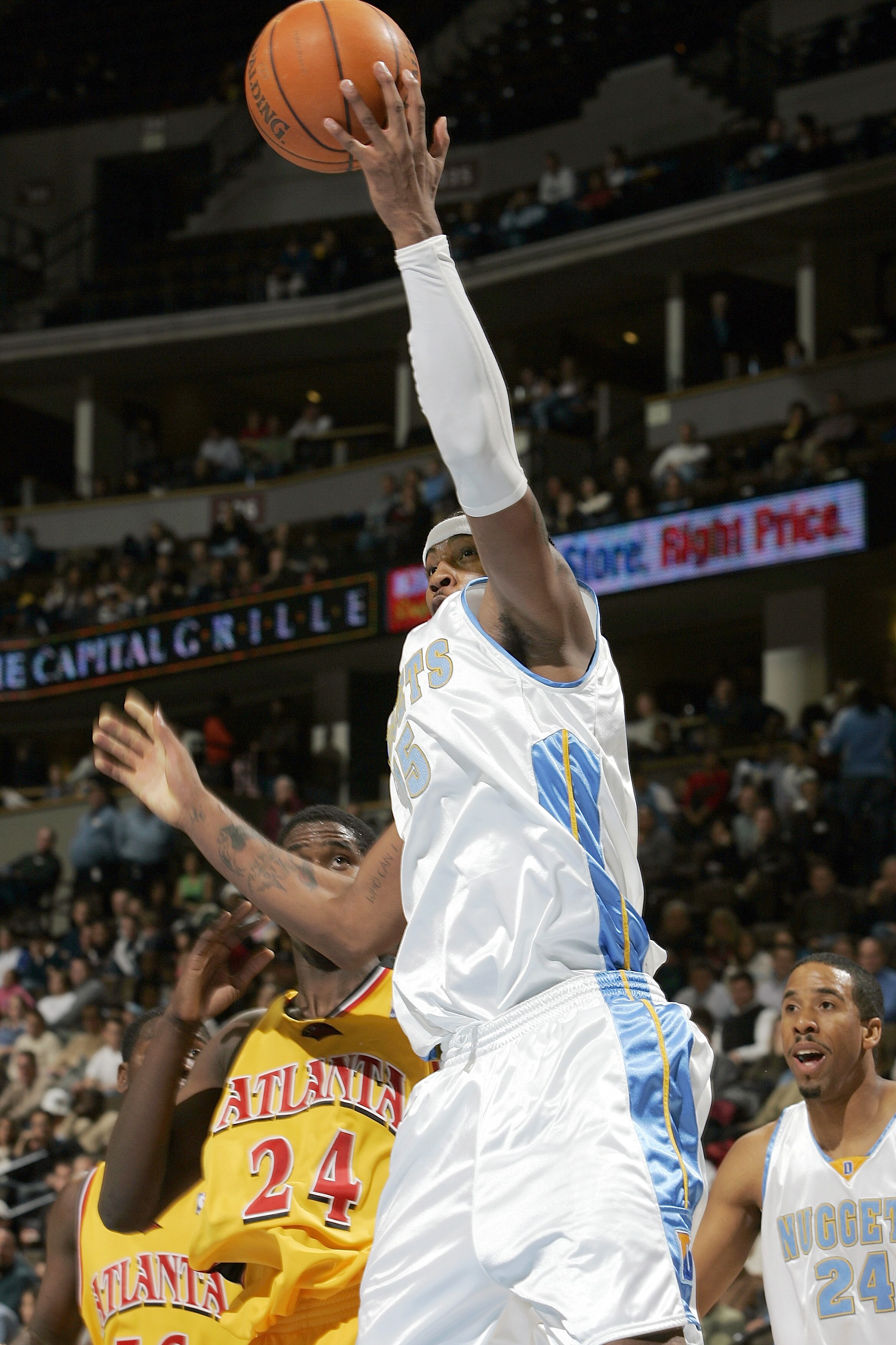 DENVER - DECEMBER 6:  Carmelo Anthony #15 of the Denver Nuggets pulls down a defensive rebound against Marvin Williams #24 of the Atlanta Hawks in the second quarter on December 6, 2005 at the Pepsi Center in Denver, Colorado.  NOTE TO USER:  User express