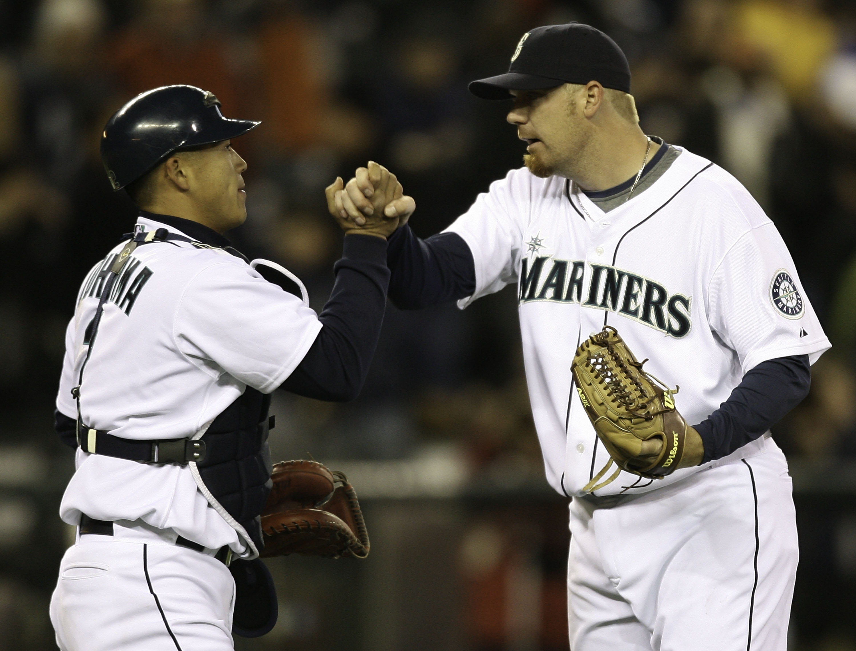 SEATTLE - MARCH 31:  Closing pitcher J.J. Putz #20 of the Seattle Mariners is congratulated by catcher Kenji Johjima #2 after defeating the Texas Rangers 5-2 in the Mariners' Home Opener on March 31, 2008 in Seattle, Washington. (Photo by Otto Greule Jr/G