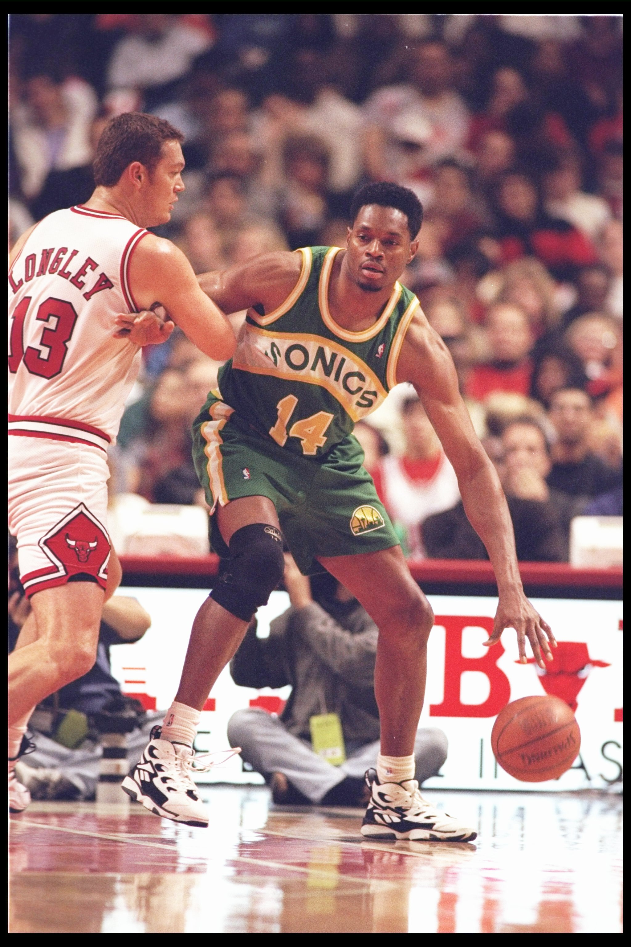 21 Oct 1995:  Forward Sam Perkins of the Seattle SuperSonics moves the ball as Chicago Bulls center Luc Longley covers him during a game at the United Center in Chicago, Illinois.  The Bulls won the game, 101-97. Mandatory Credit: Jonathan Daniel  /Allspo