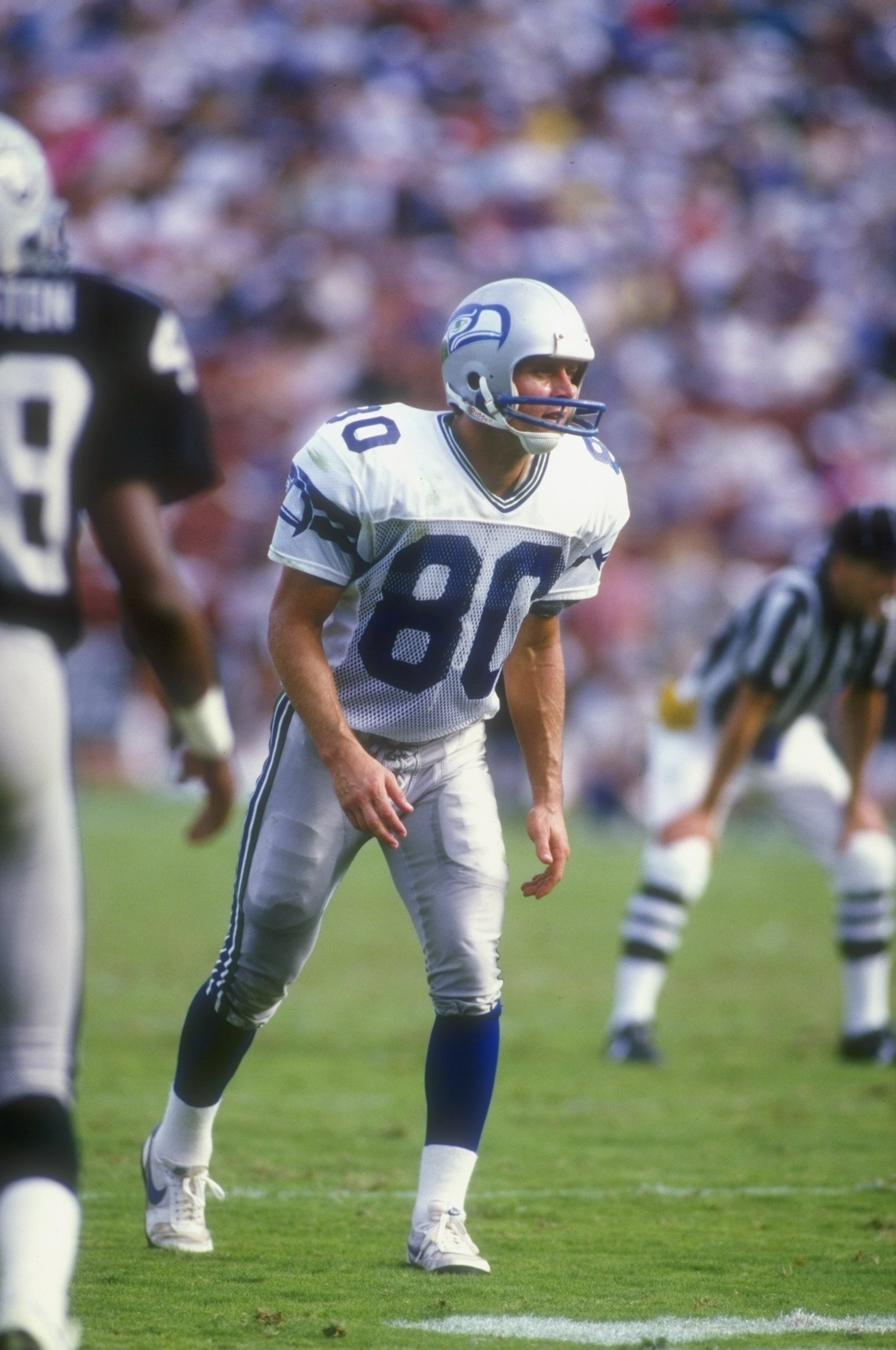 1987:  Steve Largent #80 of the Seattle Seahawks looks on during a game against the Los Angeles Raiders at the Memorial Coliseum in Los Angeles, California. The Raiders defeated the Seahawks 35-13. Mandatory Credit: Rick Stewart  /Allsport