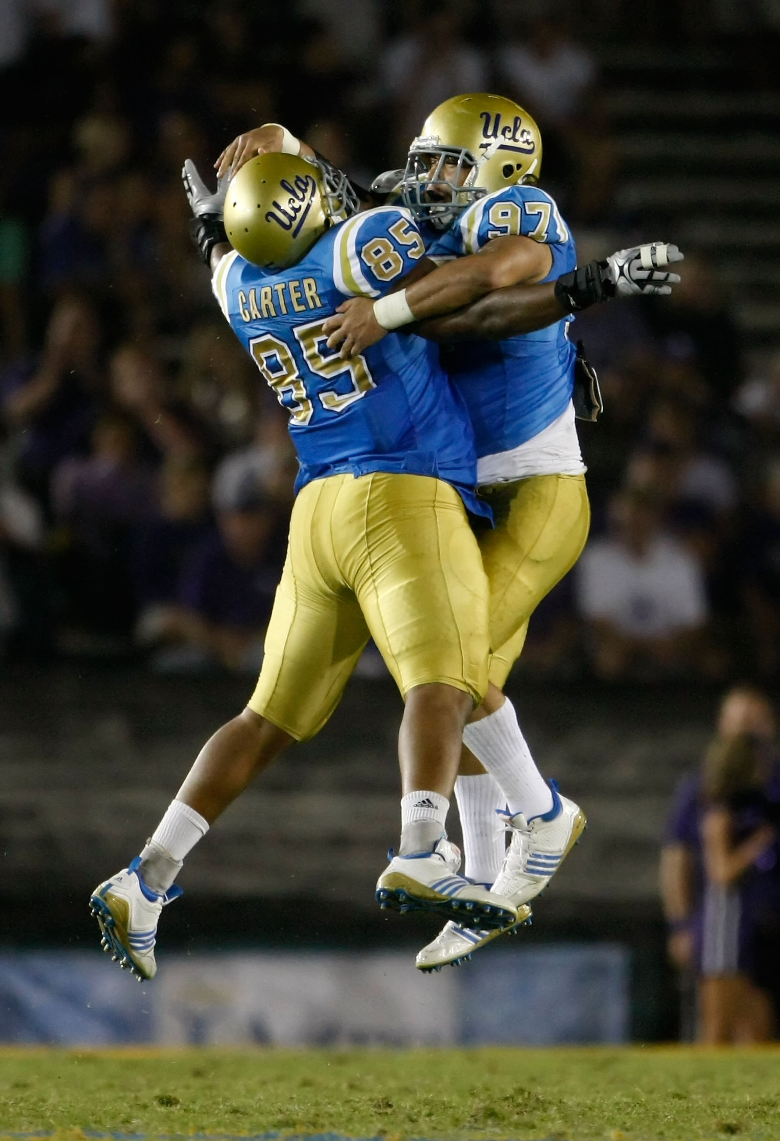 PASADENA, CA - SEPTEMBER 19:  David Carter #85 and Damien Holmes #97 of the UCLA Bruins celebrate after Holmes recorded a sack against the Kansas State Wildcats late in the fourth quarter at the Rose Bowl on September 19, 2009 in Pasadena, California. UCL