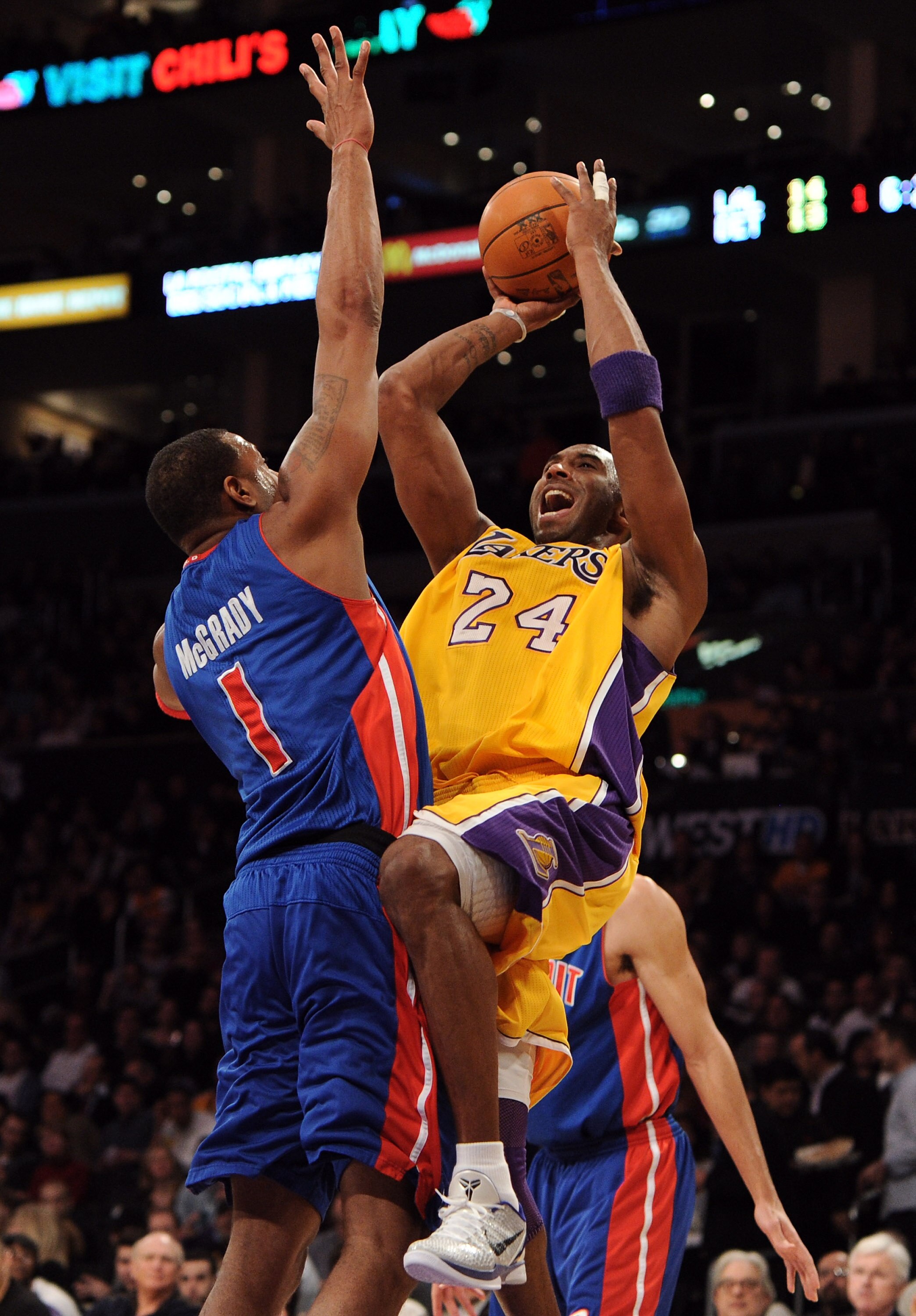 LOS ANGELES, CA - JANUARY 04:  Kobe Bryant #24 of the Los Angeles Lakers shoots a jumper over Tracy McGrady #1 of the Detroit Pistons at the Staples Center on January 4, 2011 in Los Angeles, California. NOTE TO USER: User expressly acknowledges and agrees