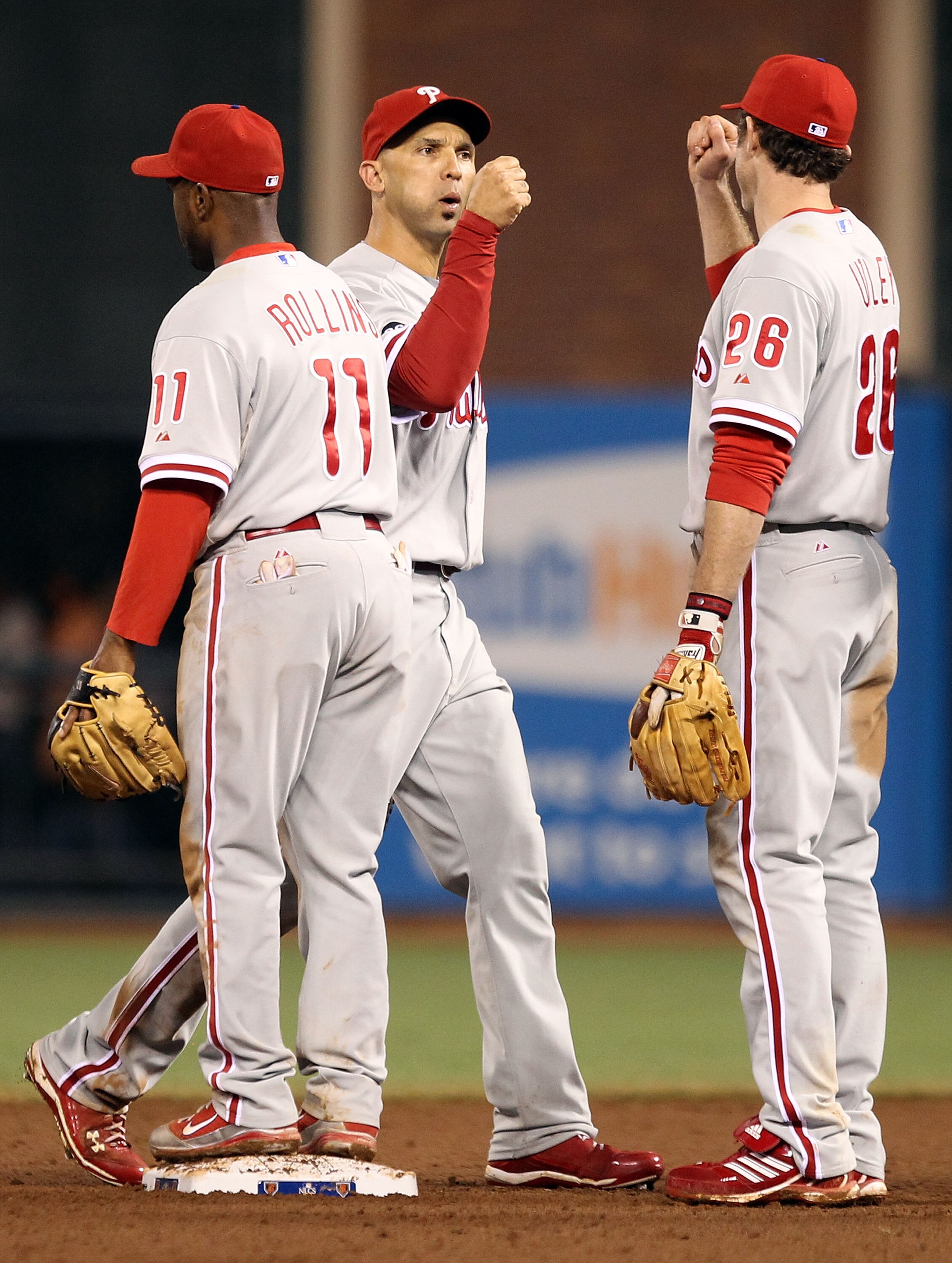 SAN FRANCISCO - OCTOBER 21:  Jimmy Rollins #11, Raul Ibanez #29, and Chase Utley #26 of the Philadelphia Phillies celebrate defeating the San Francisco Giants 4-2 in Game Five of the NLCS during the 2010 MLB Playoffs at AT&T Park on October 21, 2010 in Sa