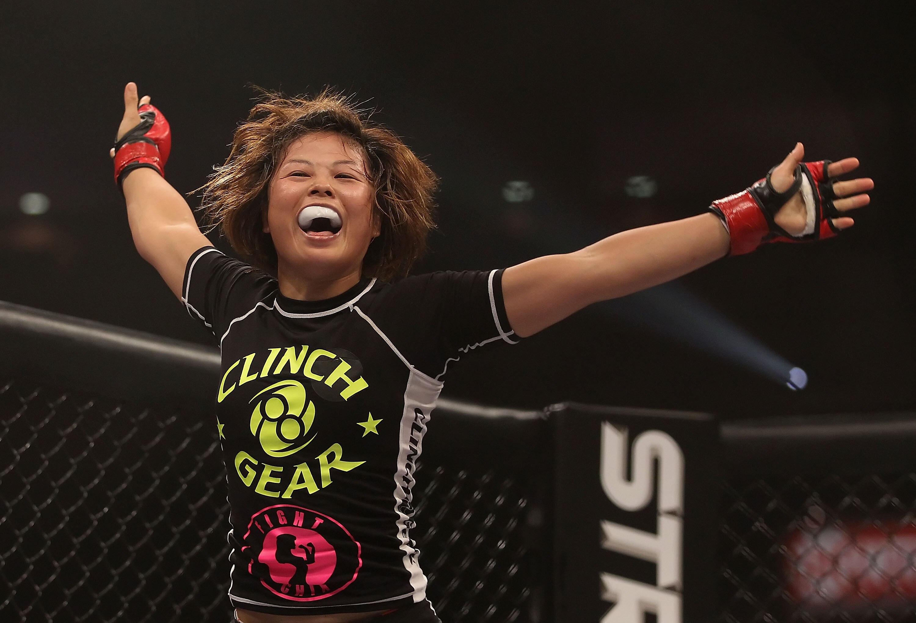 PHOENIX - AUGUST 13:  Hitomi Akano of Japan celebrates after defeating Carina Damm (not pictured) in the Strikeforce Women's Welterweight Tournament semi final bout at Dodge Theater on August 13, 2010 in Phoenix, Arizona.  (Photo by Christian Petersen/Get