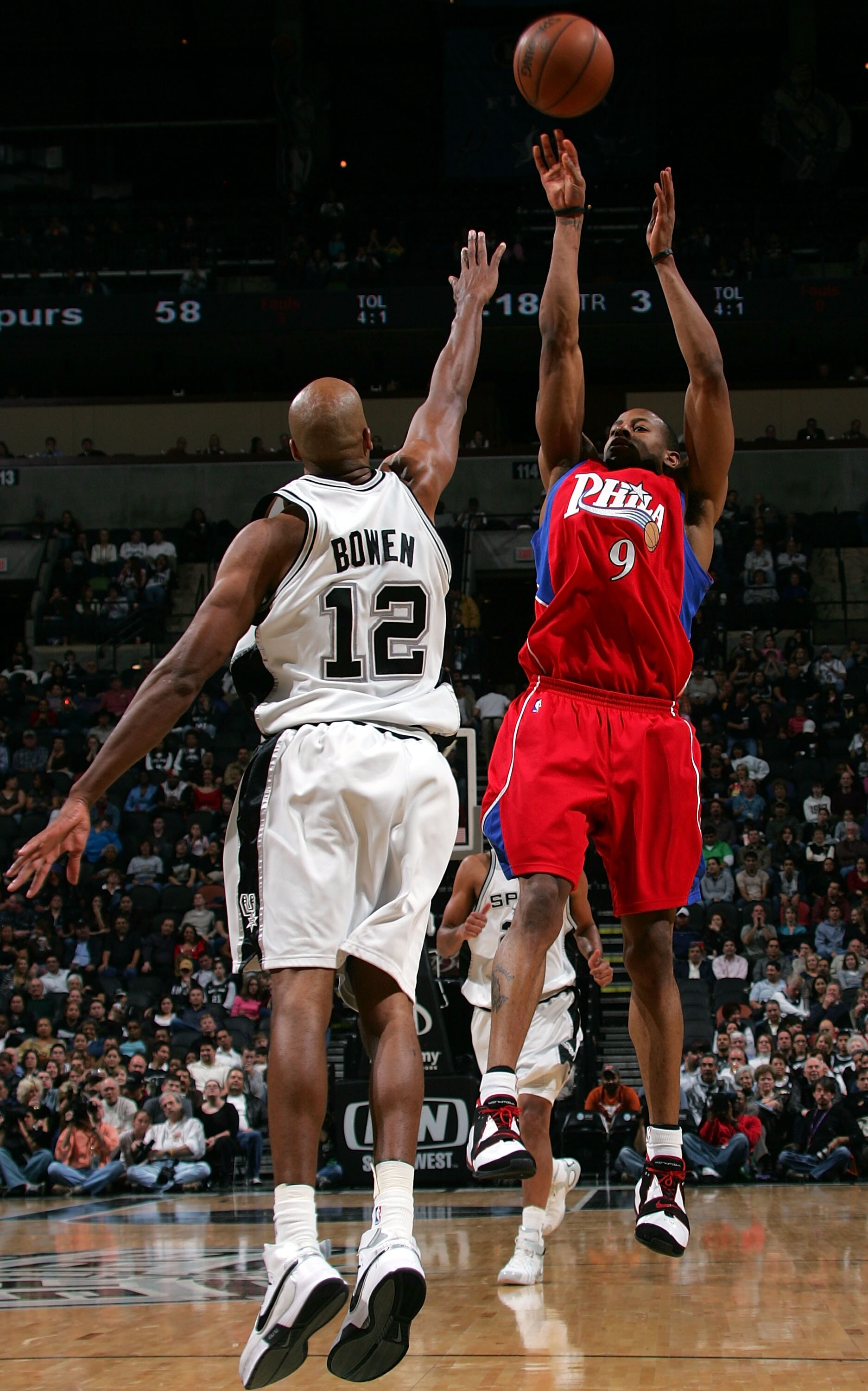 SAN ANTONIO - JANUARY 14:  Forward Andre Iguodala #9 of the Philadelphia 76ers takes a shot against Bruce Bowen #12 of the San Antonio Spurs at AT&T Center January 14, 2008 in San Antonio, Texas.  NOTE TO USER: User expressly acknowledges and agrees that,