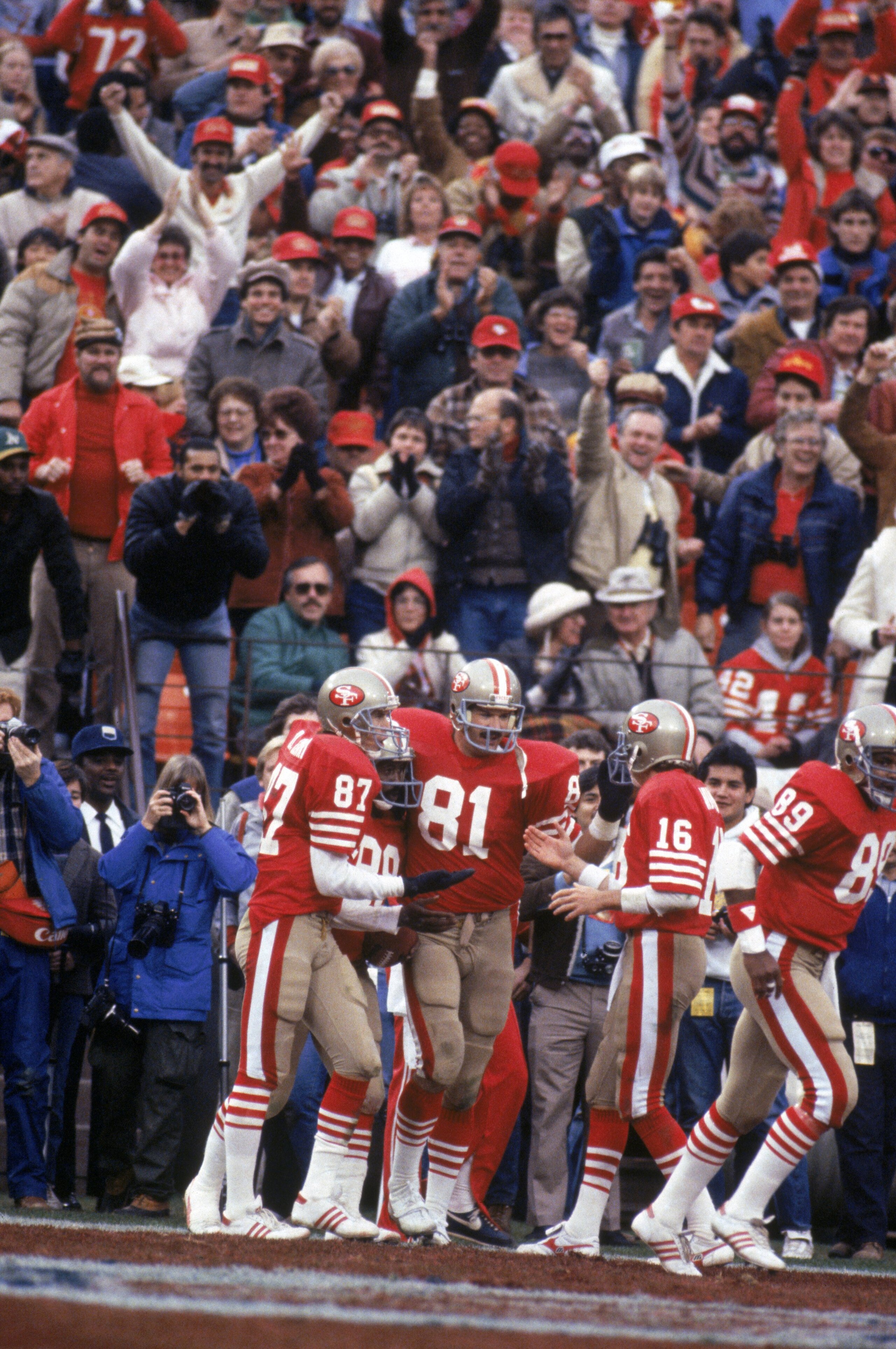 SAN FRANCISCO - JANUARY 6: Wide receiver Dwight Clark #87, tight end Russ Francis #81 and quarterback Joe Montana #16 of the San Francisco 49ers celebrate during the 1984 NFC Championship Game against the Chicago Bears at Candlestick Park on January 6, 1 SAN FRANCISCO - JANUARY 6: Wide receiver Dwight Clark #87, tight end Russ Francis #81 and quarterback Joe Montana #16 of the San Francisco 49ers celebrate during the 1984 NFC Championship Game against the Chicago Bears at Candlestick Park on January 6, 1