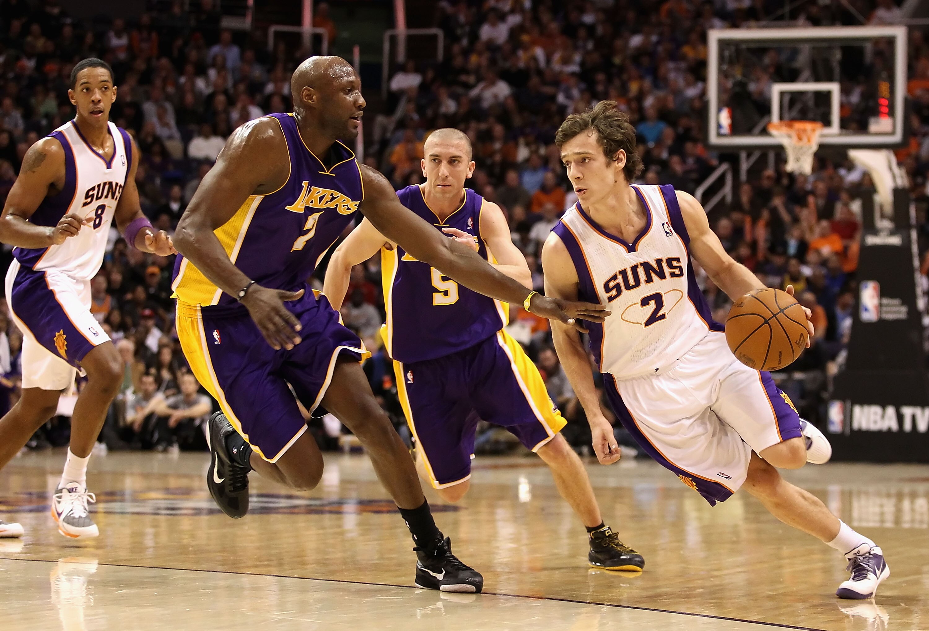 PHOENIX - JANUARY 05: Goran Dragic #2 of the Phoenix Suns drives the ball past Lamar Odom #7 of the Los Angeles Lakers during the NBA game at US Airways Center on January 5, 2011 in Phoenix, Arizona. NOTE TO USER: User expressly acknowledges and agrees th PHOENIX - JANUARY 05: Goran Dragic #2 of the Phoenix Suns drives the ball past Lamar Odom #7 of the Los Angeles Lakers during the NBA game at US Airways Center on January 5, 2011 in Phoenix, Arizona. NOTE TO USER: User expressly acknowledges and agrees th