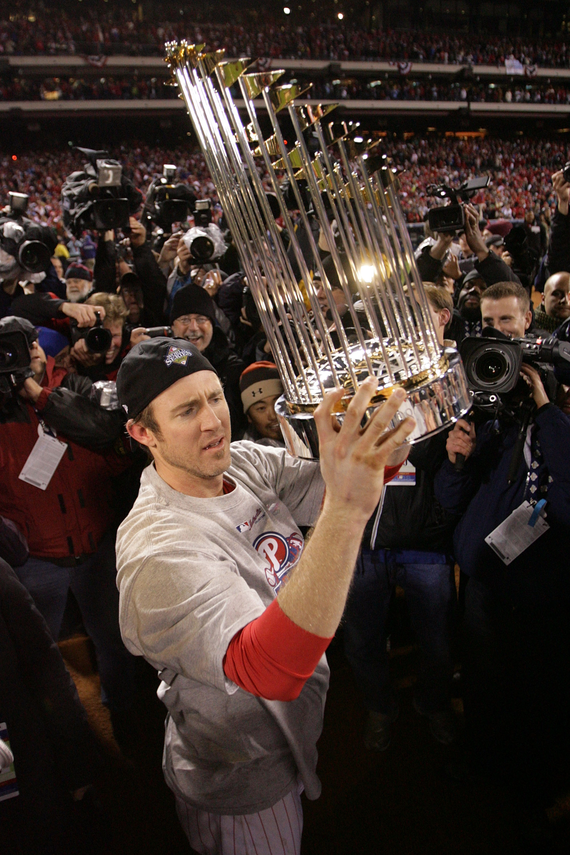 PHILADELPHIA - OCTOBER 29:  Chase Utley #26 of the Philadelphia Phillies celebrates with the World Series trophy after their 4-3 win against the Tampa Bay Rays during the continuation of game five of the 2008 MLB World Series on October 29, 2008 at Citize