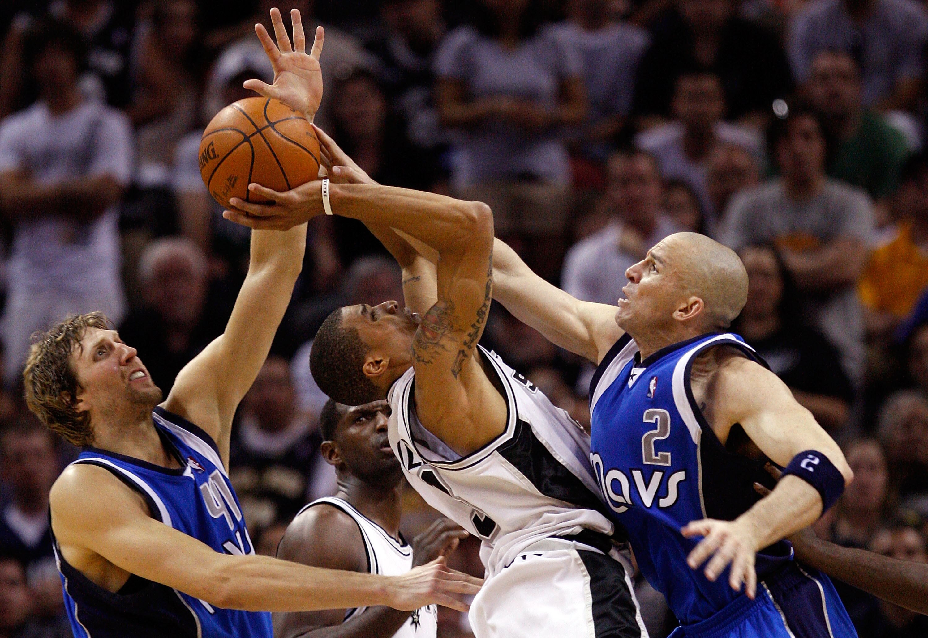 SAN ANTONIO - APRIL 25:  Guard George Hill #3 of the San Antonio Spurs takes a shot against Jason Kidd #2 and Dirk Nowitzki #41 of the Dallas Mavericks in Game Four of the Western Conference Quarterfinals during the 2010 NBA Playoffs at AT&T Center on Apr