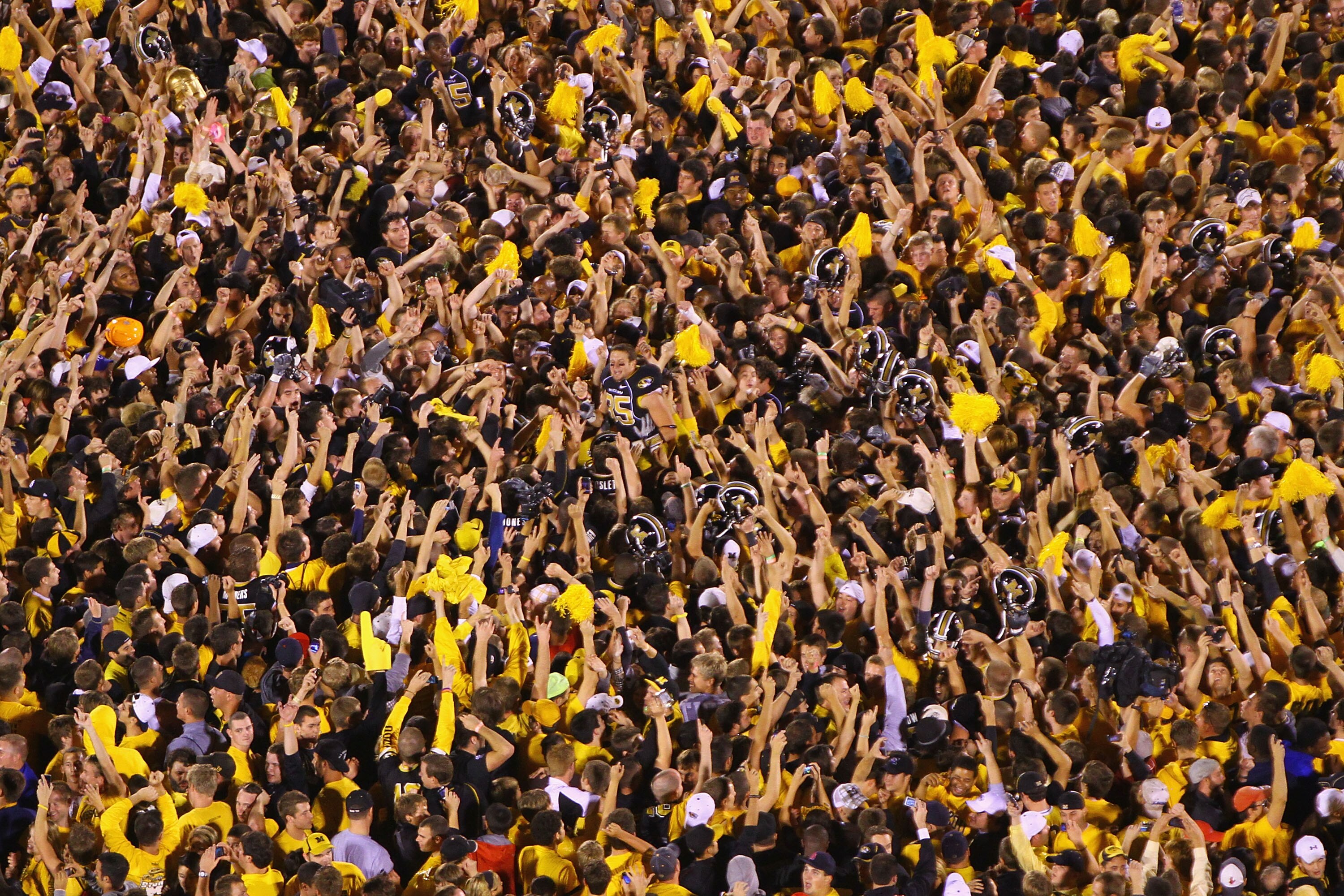 COLUMBIA, MISSOURI - OCTOBER 23: Missouri Tigers fans swarm the field after upsetting the Oklahoma Sooners at Faurot Field/Memorial Stadium on October 23, 2010 in Columbia, Missouri.  The Tigers beat the Sooners 36-27.  (Photo by Dilip Vishwanat/Getty Ima