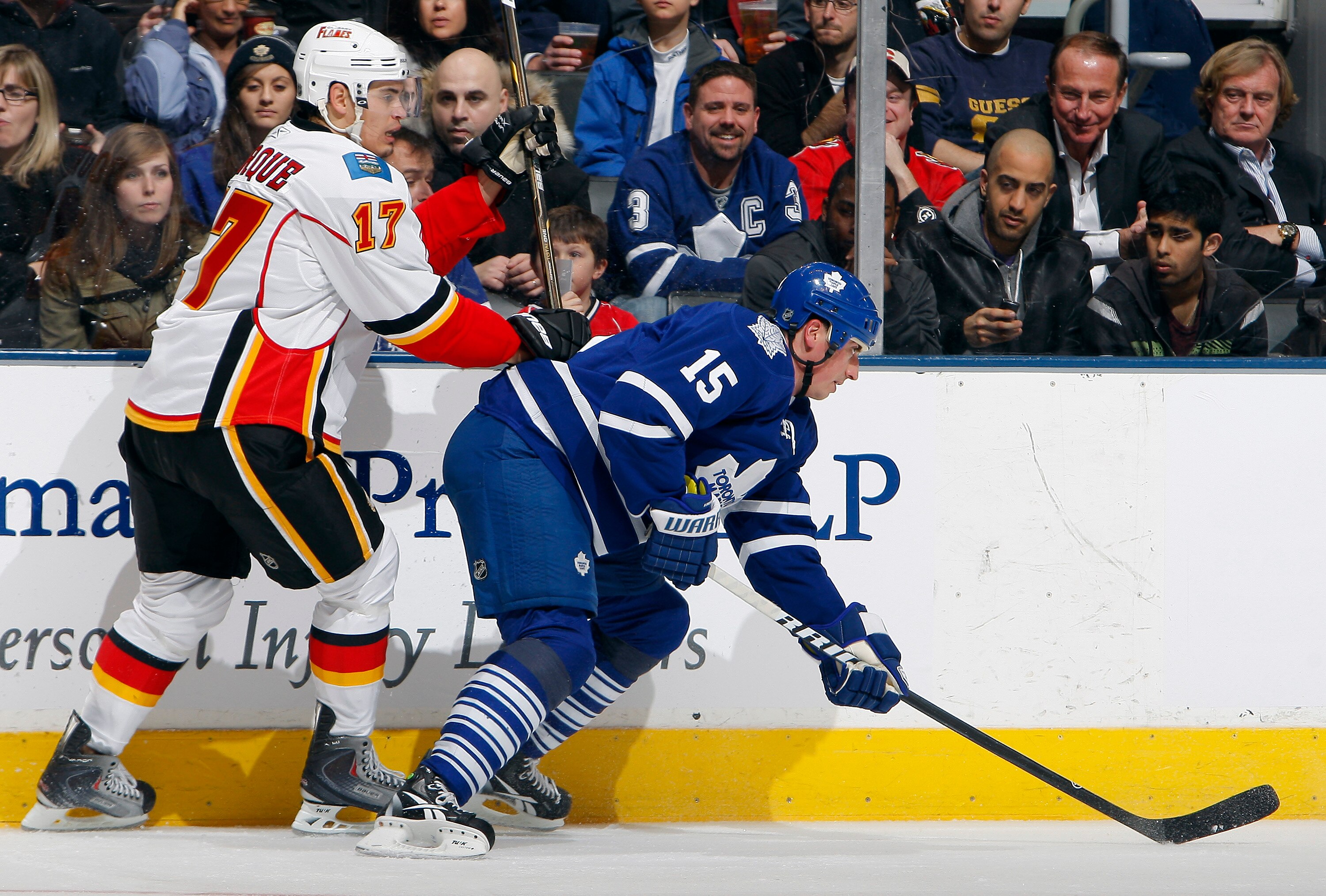 TORONTO, CANADA - JANUARY 15: Tomas Kaberle #15 of the Toronto Maple Leafs gets hit by Rene Bourque #17 of the Calgary Flames during game action at the Air Canada Centre January 15, 2011 in Toronto, Ontario, Canada. (Photo by Abelimages/Getty Images) TORONTO, CANADA - JANUARY 15: Tomas Kaberle #15 of the Toronto Maple Leafs gets hit by Rene Bourque #17 of the Calgary Flames during game action at the Air Canada Centre January 15, 2011 in Toronto, Ontario, Canada. (Photo by Abelimages/Getty Images)