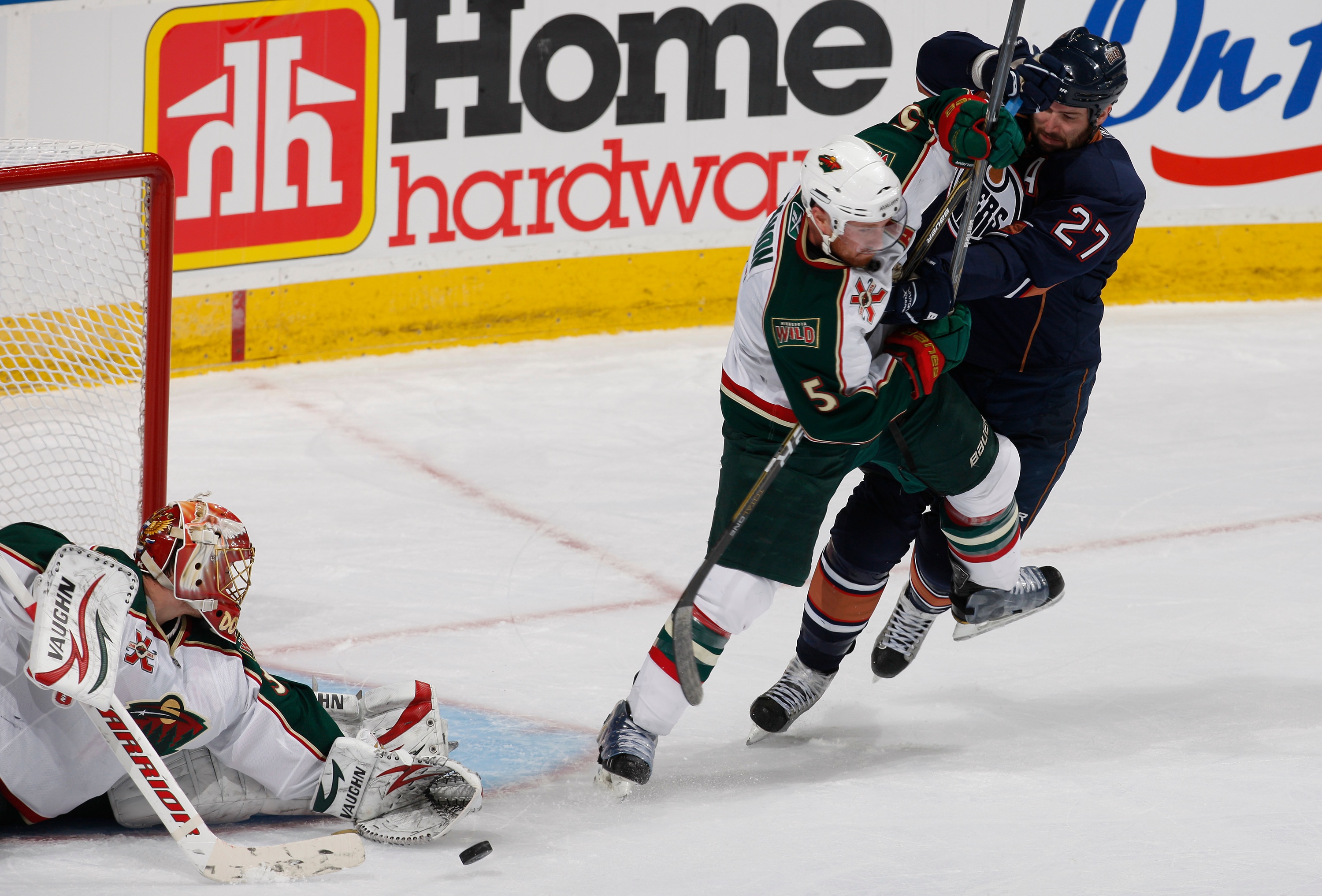 EDMONTON, CANADA - JANUARY 18: Dustin Penner #27 of the Edmonton Oilers battles with Greg Zanon #5 of the Minnesota Wild as Anton Khudobin #35 covers up at Rexall Place January 18, 2011 in Edmonton, Alberta, Canada. (Photo by Dale MacMillan/Getty Images) EDMONTON, CANADA - JANUARY 18: Dustin Penner #27 of the Edmonton Oilers battles with Greg Zanon #5 of the Minnesota Wild as Anton Khudobin #35 covers up at Rexall Place January 18, 2011 in Edmonton, Alberta, Canada. (Photo by Dale MacMillan/Getty Images)