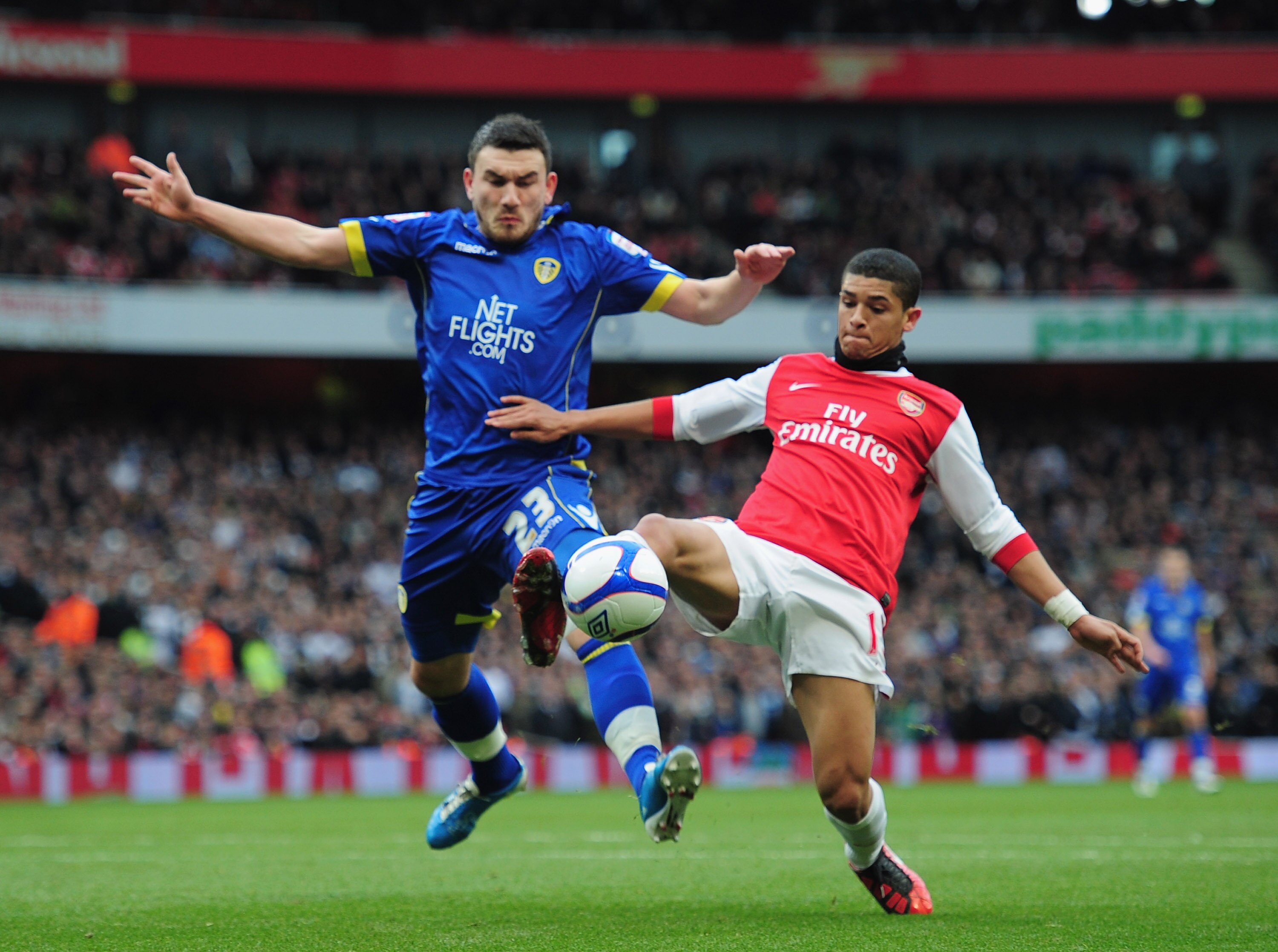 LONDON, ENGLAND - JANUARY 08: Denilson of Arsenal holds off a challenge from Robert Snodgrass of Leeds United during the FA Cup sponsored by E.ON 3rd Round match between Arsenal and Leeds United at Emirates Stadium on January 8, 2011 in London, England. LONDON, ENGLAND - JANUARY 08: Denilson of Arsenal holds off a challenge from Robert Snodgrass of Leeds United during the FA Cup sponsored by E.ON 3rd Round match between Arsenal and Leeds United at Emirates Stadium on January 8, 2011 in London, England.