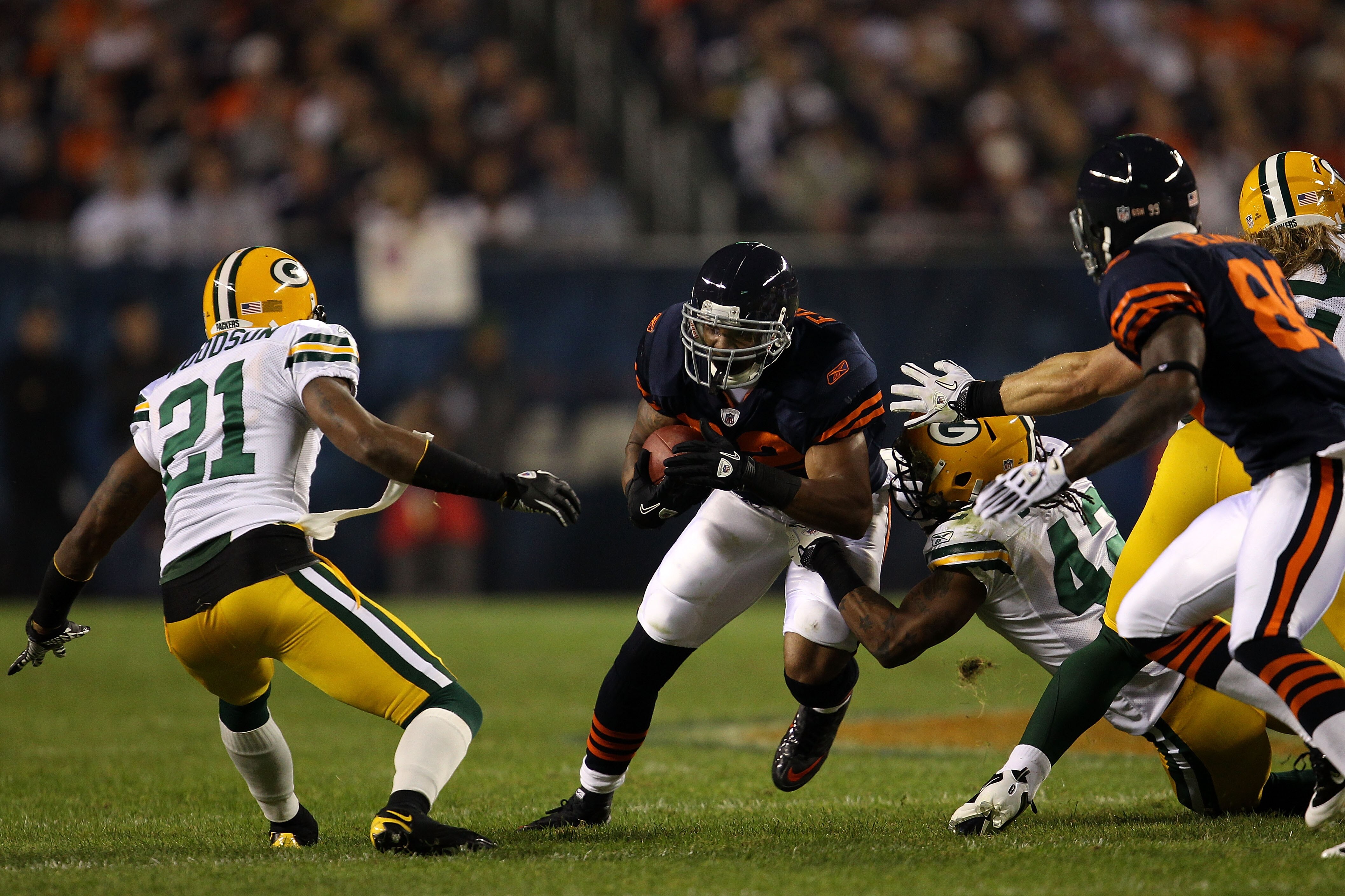 CHICAGO - SEPTEMBER 27:  Matt Forte #22 of the Chicago Bears runs the ball in the first quarter against Charles Woodson #21 and Morgan Burnett #42 of the Green Bay Packers at Soldier Field on September 27, 2010 in Chicago, Illinois.  (Photo by Jonathan Da