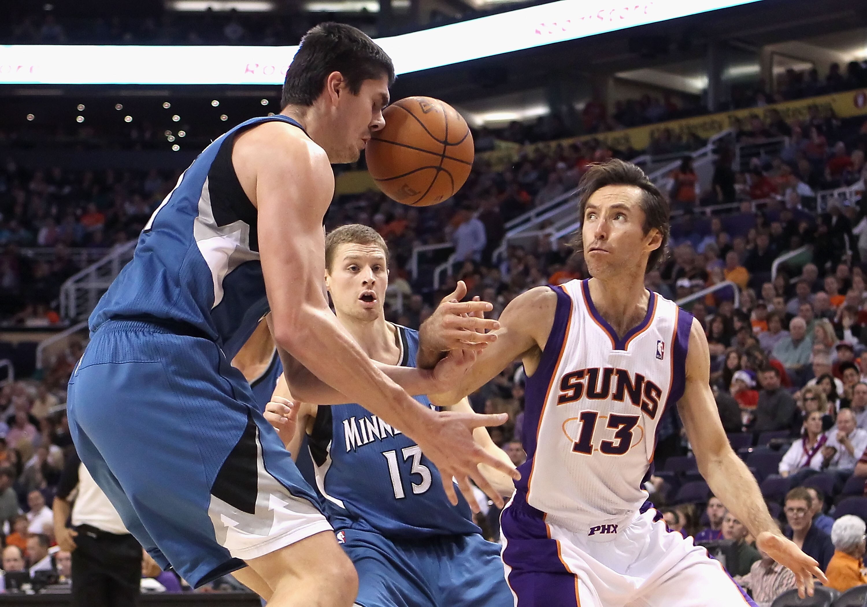 PHOENIX - DECEMBER 15:  Darko Milicic #31 of the Minnesota Timberwolves gets hit in the face by the ball as Steve Nash #13 of the Phoenix Suns loses control during the NBA game at US Airways Center on December 15, 2010 in Phoenix, Arizona. The Suns defeat
