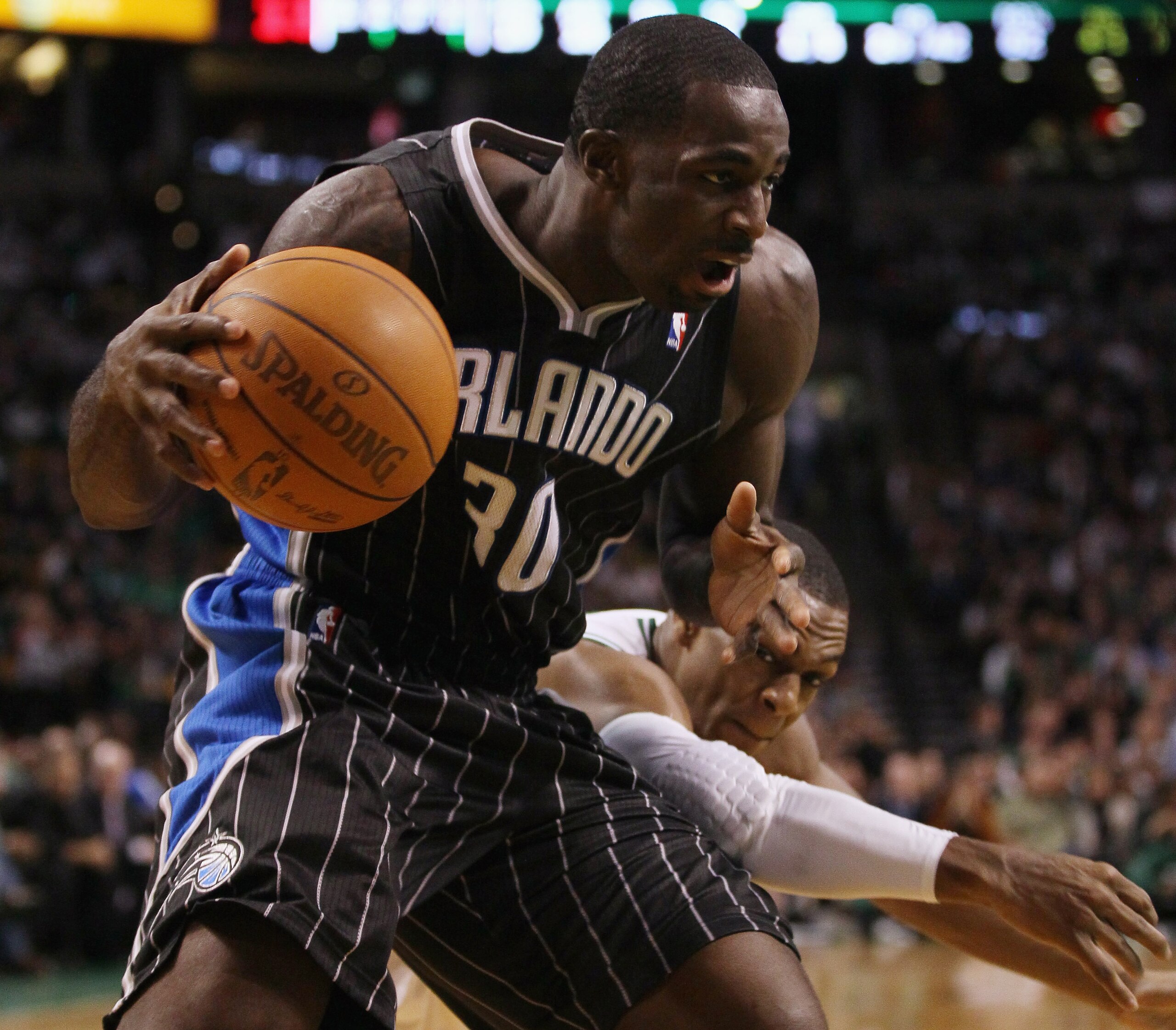 BOSTON, MA - JANUARY 17: Brandon Bass #30 of the Orlando Magic tries to keep the ball as Rajon Rondo #9 of the Boston Celtics defends on January 17, 2011 at the TD Garden in Boston, Massachusetts. The Celtics defeated the Magic 109-106. NOTE TO USER: U BOSTON, MA - JANUARY 17: Brandon Bass #30 of the Orlando Magic tries to keep the ball as Rajon Rondo #9 of the Boston Celtics defends on January 17, 2011 at the TD Garden in Boston, Massachusetts. The Celtics defeated the Magic 109-106. NOTE TO USER: U