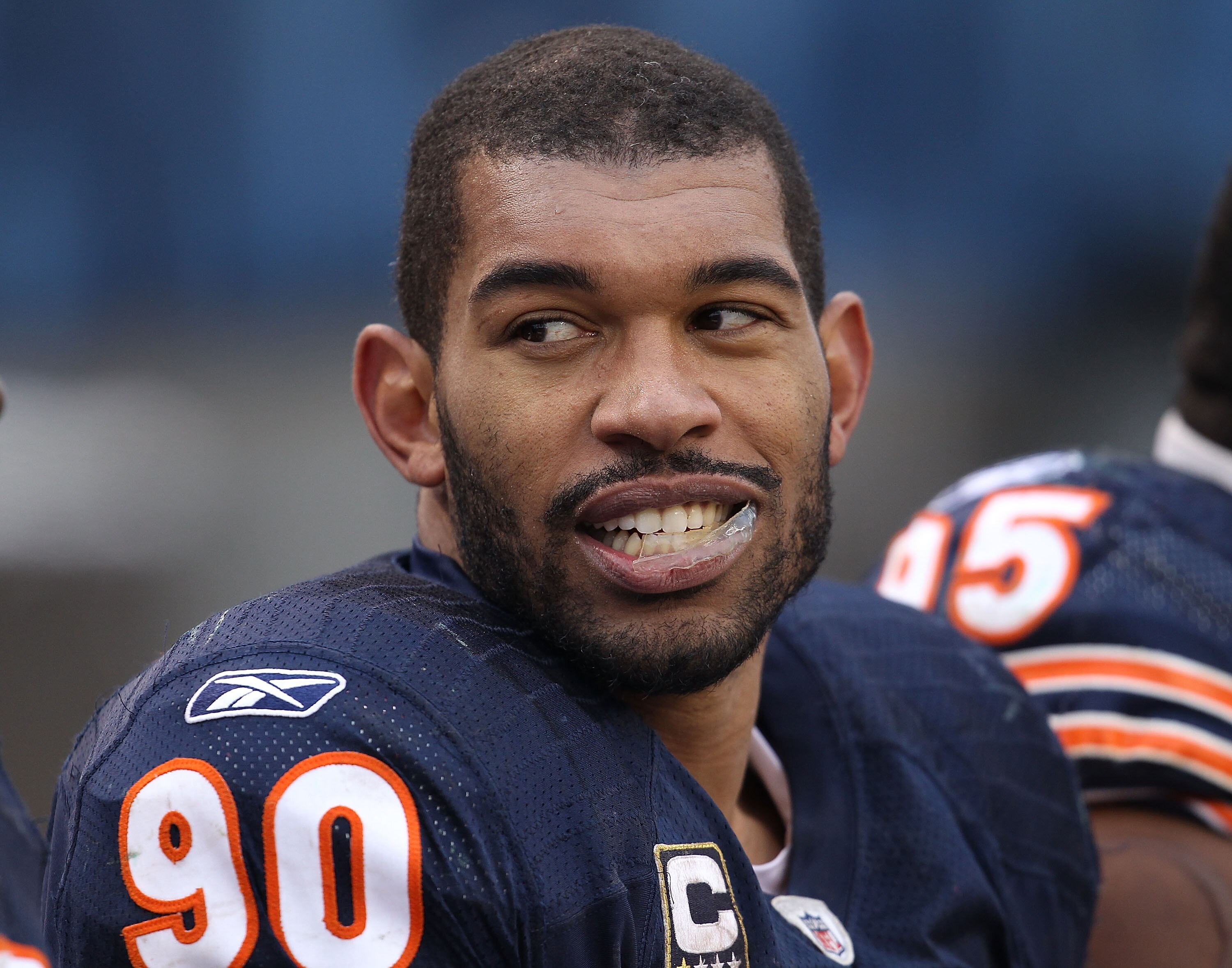 CHICAGO, IL - DECEMBER 26: Julius Peppers #90 of the Chicago Bears talks with a teammate on the bench during a game against the New York Jets at Soldier Field on December 26, 2010 in Chicago, Illinois. The Bears defeated the Jets 38-34. (Photo by Jonathan