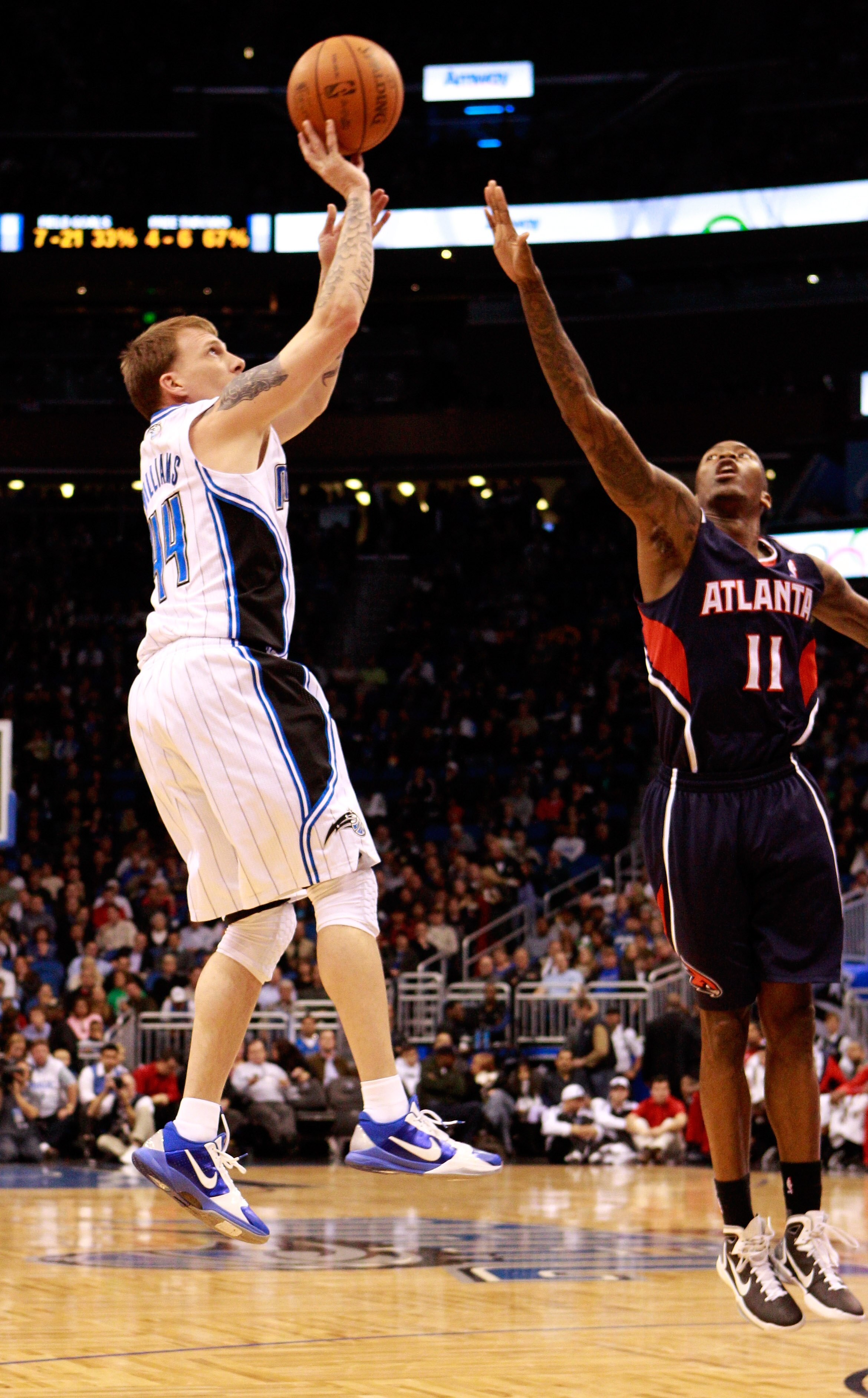 ORLANDO, FL - DECEMBER 06:  Jason Williams #44 of the Orlando Magic attempts a shot over Jamal Crawford #11 of the Atlanta Hawks during the game at Amway Arena on December 6, 2010 in Orlando, Florida. NOTE TO USER: User expressly acknowledges and agrees t