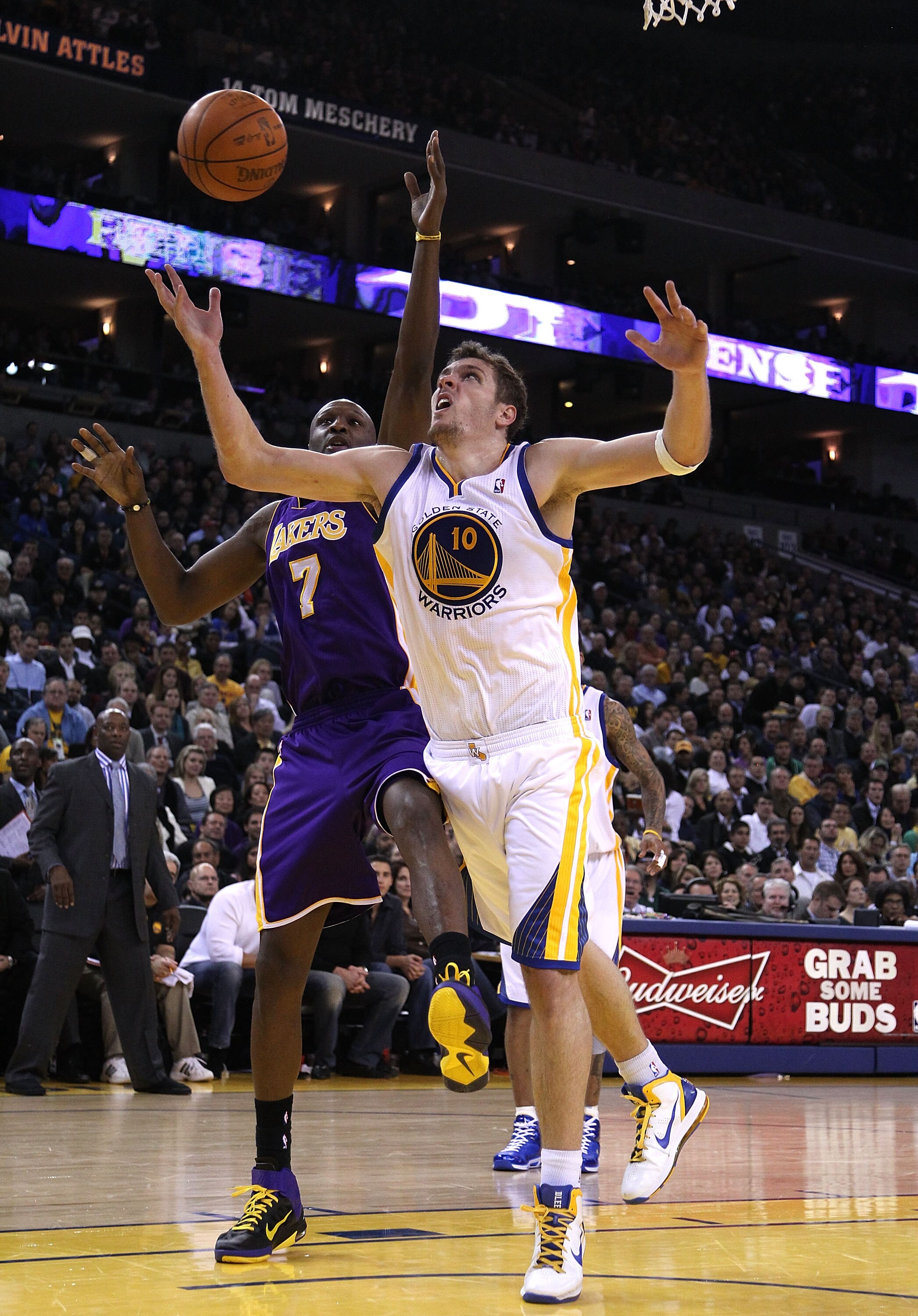 OAKLAND, CA - JANUARY 12:  Lamar Odom #7 of the Los Angeles Lakers and David Lee #10 of the Golden State Warriors go for a rebound at Oracle Arena on January 12, 2011 in Oakland, California. NOTE TO USER: User expressly acknowledges and agrees that, by do